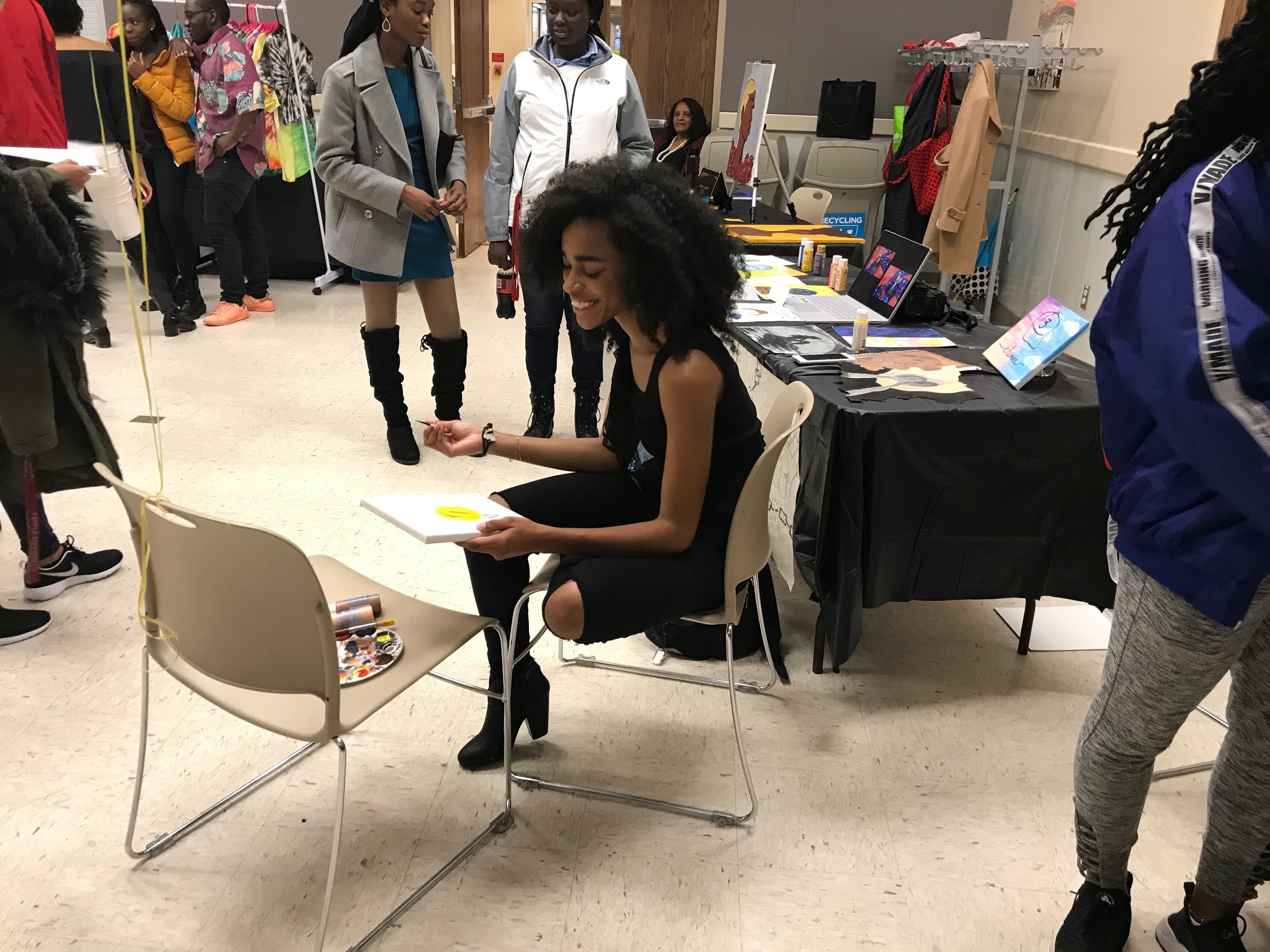 Misha Bucknor, sophomore kinesiology major, not only brought her paintings, but did a live painting session at the show. Photo by Amina Lampkin.