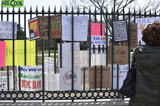 Protestors stuck their signs on fences in downtown Washington D.C. after the 2018 student-led demonstration calling for gun reform, March for Our Lives. (Iman Hassen/The Black Explosion)