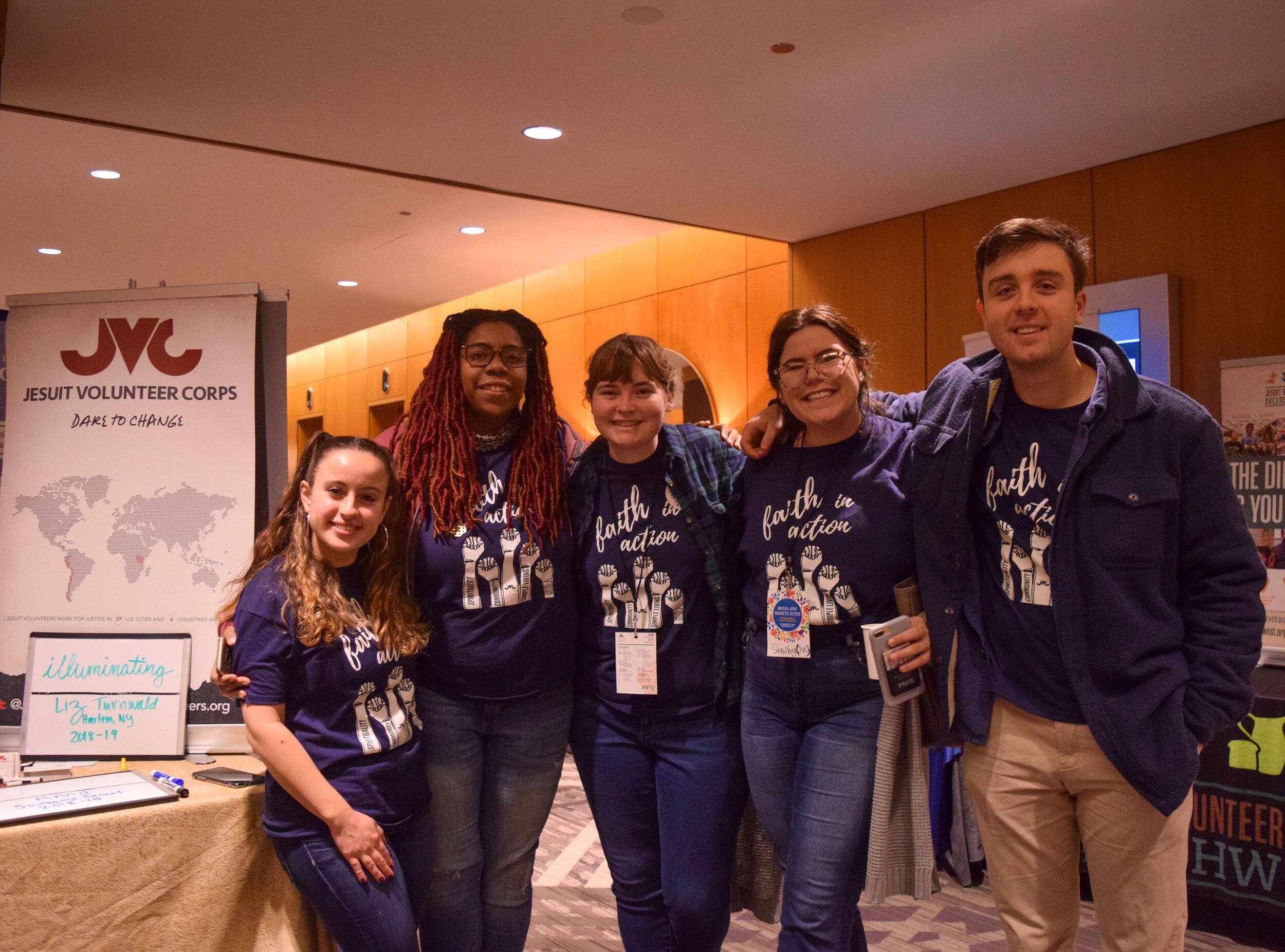  Members of the Jesuit Volunteer Corp stand by their table at the 2019 Ignatian Family Teach-In for Justice in Washington, D.C., to promote their program. JVC members are recent college graduates who are sent to cities throughout the U.S. to do a yea