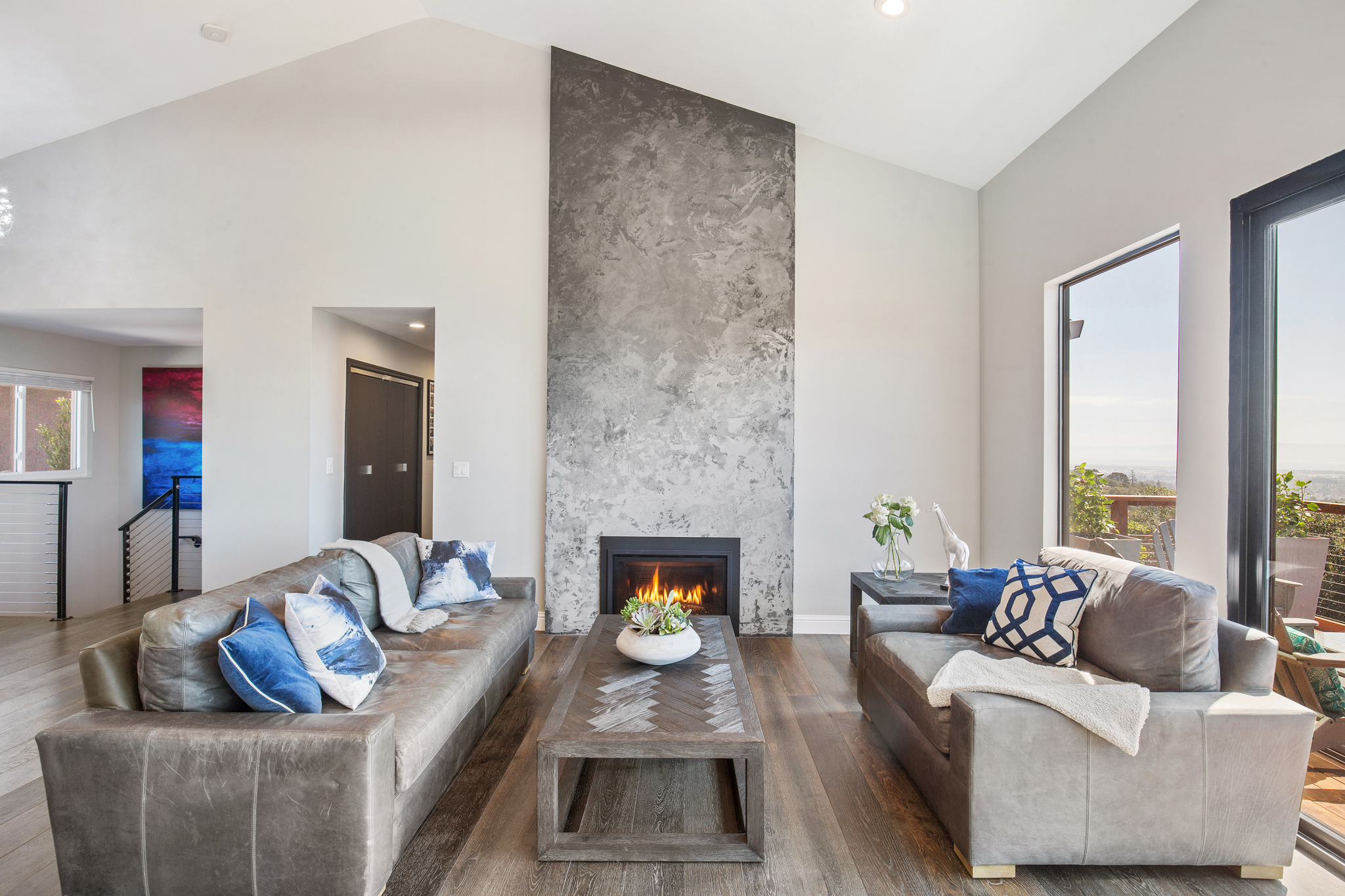 16’ Vaulted ceilings with a custom, hand troweled gas fireplace. Truly a unique piece of art.