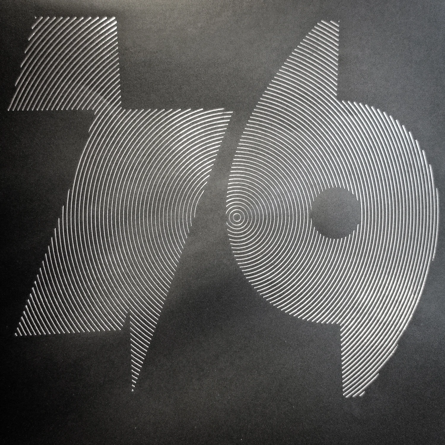 • Exciting project to be released on December 15. Live from the pressing plant, a photo sample of the box cover design. Silver hot foil print on black offset paper.