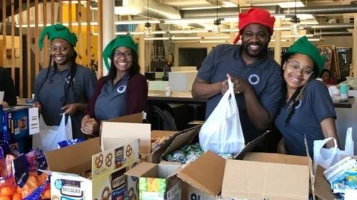 2018/19 AmeriCorps members pack meals for students during the winter break.