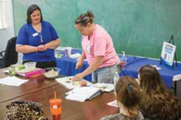 Nutrition classes led by Kacy Wiley (l) have changed the way Ali Sanders (r) shops and cooks. Photo by Stephen Patton 