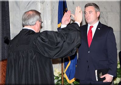 Kentucky Agriculture Commissioner Ryan F. Quarles, right, is sworn into office by state Chief Justice John D. Minton Jr. on Monday in the Capitol Rotunda in Frankfort. (Kentucky Department of Agriculture photo)