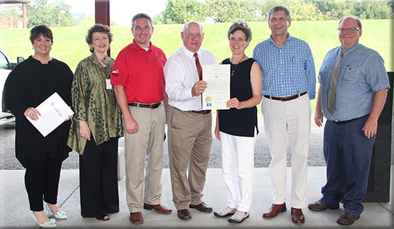 Warren Beeler, center, executive director of the Governor's Office of Agricultural Policy, presents a proclamation from Gov. Matt Bevin declaring Aug. 7-13 Farmers' Market Week in Kentucky. Also pictured are, from left: Kelly Munson, senior vice president, WellCare Health Plans; Dr. Connie White, deputy commissioner, Kentucky Department for Public Health; Agriculture Commissioner Ryan Quarles; Carol Baumann, chair of the Community Farm Alliance board; CFA executive director Martin Richards; and John Johnson, USDA. (Kentucky Department of Agriculture photo)
