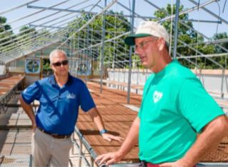 Robbie Smith and Keith Veech discuss Veech's new propagation house, buildt on the bones of the old hog nursery barn.