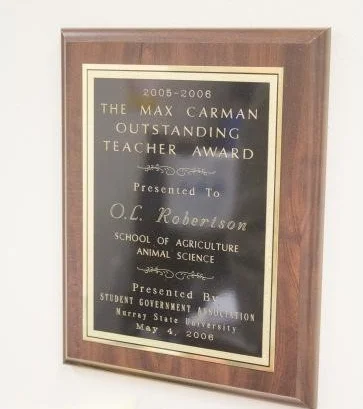 The 2005 – 2006 Max Carman Outstanding Teacher Award still hangs proudly in Robertson’s office. Photo: McKenna Dosier