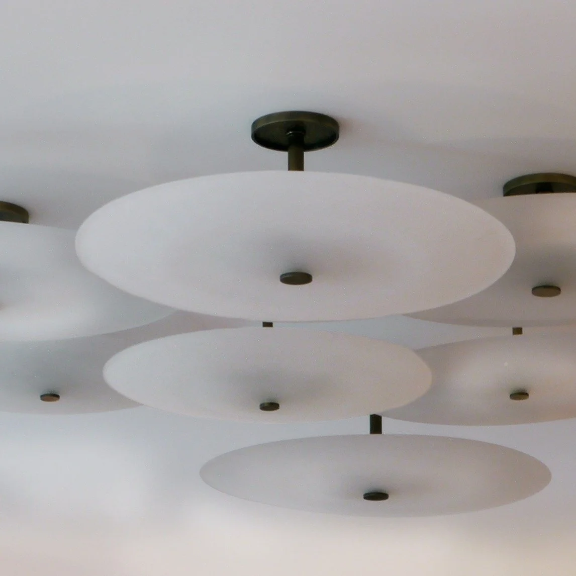 Our Glass Saucer Cluster is a Bone Simple team favorite. These hand-blown saucers seem to effortlessly hover in a room, but behind their quiet elegance is an intense craftsmanship&mdash;fire, breath, and a steady hand guiding each piece into being. T