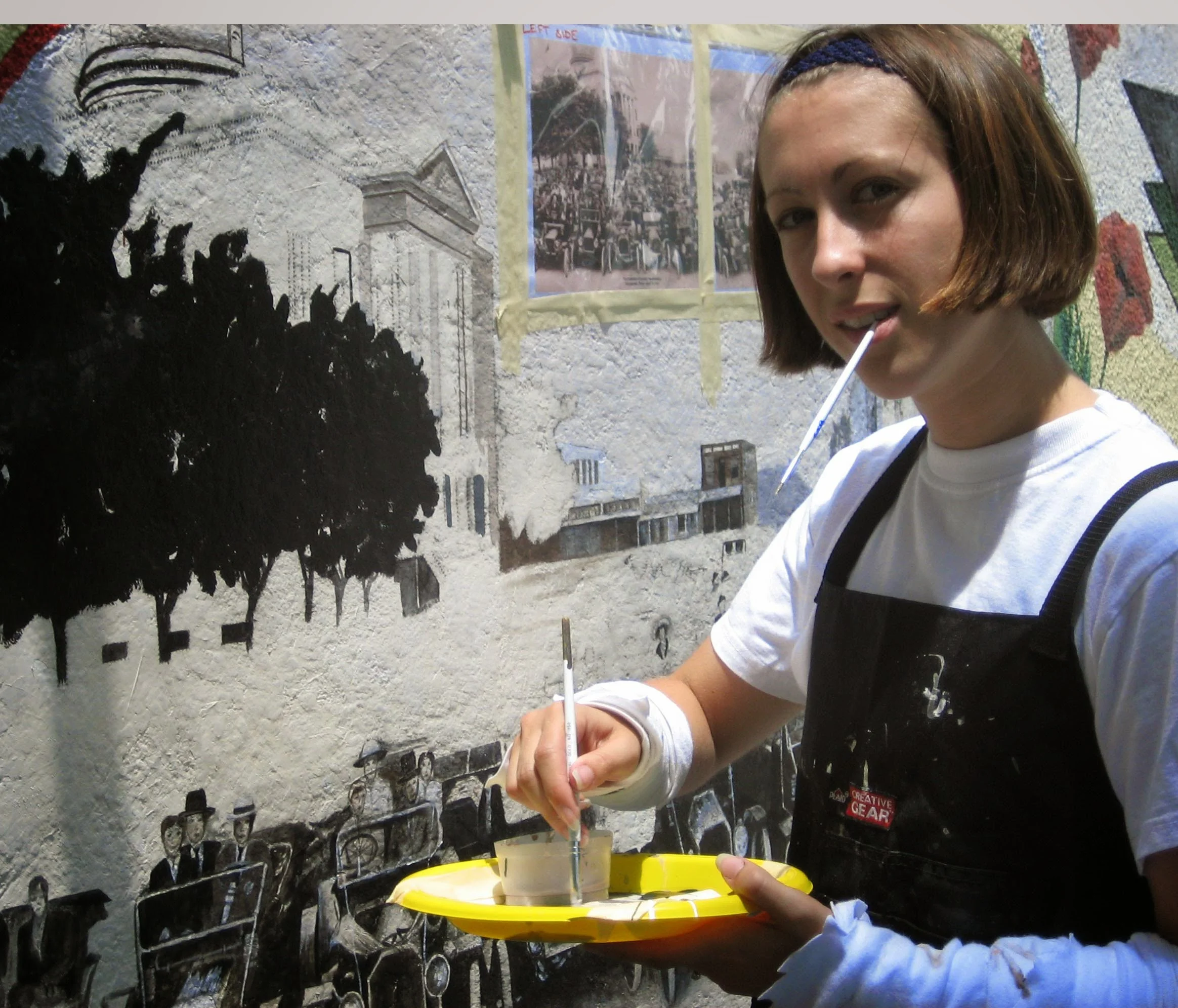 Sarah Blankenship working on details of the center photo, Courthouse and vehicles from 1912 photo of Southwestern University's Homecoming.