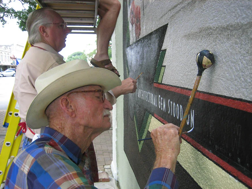 Hollace Baker and his son Gordan Baker using traditional sign painting methods.