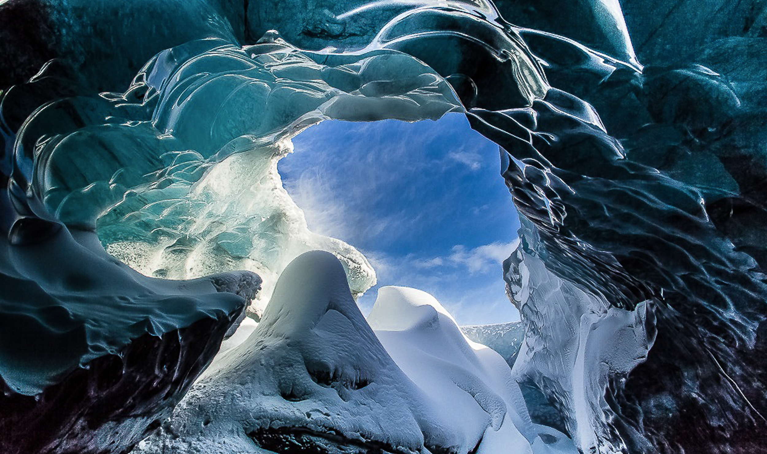The colours inside an ice-cave differ due to the daylight and sunlight outside that gets in through holes and cracks in the ice.  JONAA©Agust Runarsson