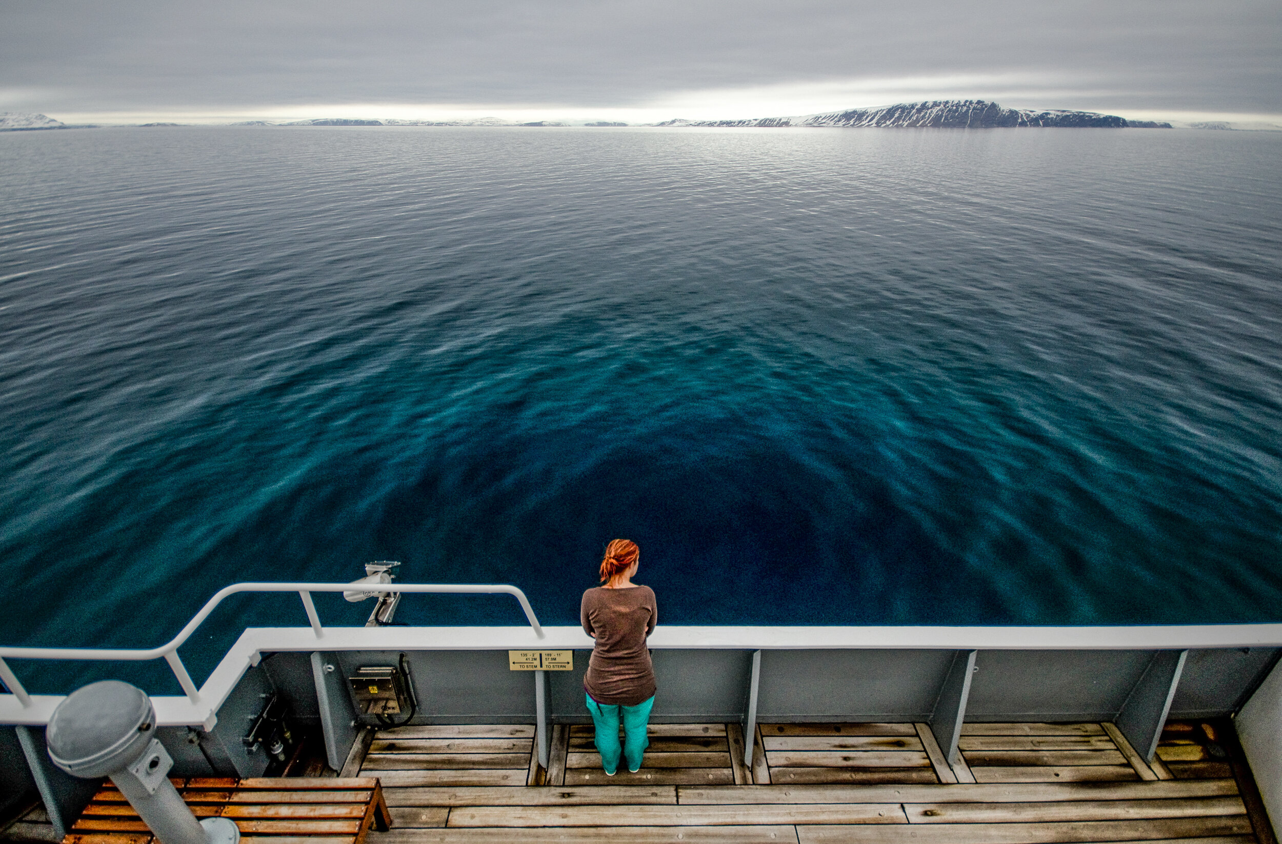 SAMS oceanographer Dr Marie Porter looks out to sea off Rijpfjorden, Svalbard during an Arctic PRIZE project research cruise on board the RRS James Clark Ross. JONAA©Dr Callum Whyte, SAMS