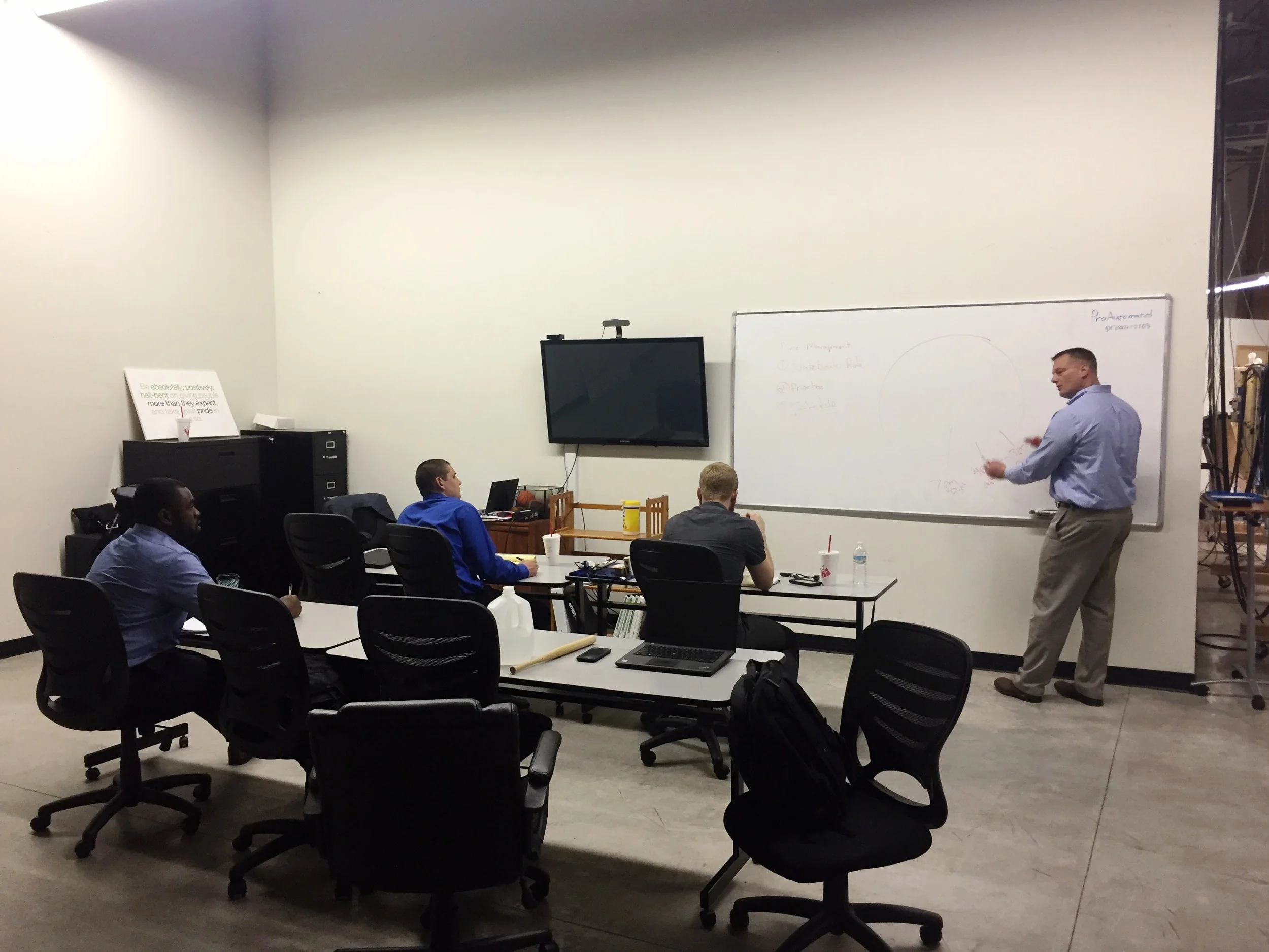 Jerry Savage trains new ProAutomated engineers on jobsite time management, part of the professional training that supplements technical information.
