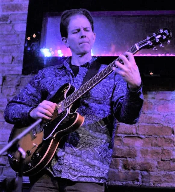 David Winge Guest Teaching Artist - Vocal Jazz Intensive Dennis Winge is a professional guitarist living in Ithaca, NY who is actively involved in teaching and performing in a variety of musical settings throughout the Finger Lakes. Before moving to the Finger Lakes in 2012, Dennis Winge was one of the most ubiquitous jazz and pop/rock/soul guitarists in the New York City area and played with musicians who played in bands that featured artists such as Billy Joel, Stan Getz, Paul Simon, James Taylor, Tony Bennett, Herbie Hancock. He has performed at such prestigious venues as Carnegie Hall, the Los Angeles Music Awards, and in many countries. Dennis has studied with some of New York City’s finest guitarists including Jack Wilkins and Ron Parmentier. Some of the names he has played with in the rock world are Clifford Carter (who played Paul Simon, James Taylor), Jon Cobert (who played with John Lennon), and Cheetah Chrome (who played with punk band The Dead Boys). In jazz he has worked with Bill Crow (who played with Stan Getz, Gerry Mulligan); Gene Bertoncini (who played with Buddy Rich, Tony Bennett); Shunzo Ohno (who played with Wayne Shorter, Herbie Hancock); Bob Meyer (who played with Joe Lovano, John Abercrombie); David Budway (who played with Jeff ‘Tain’ Watts, Regina Carter).