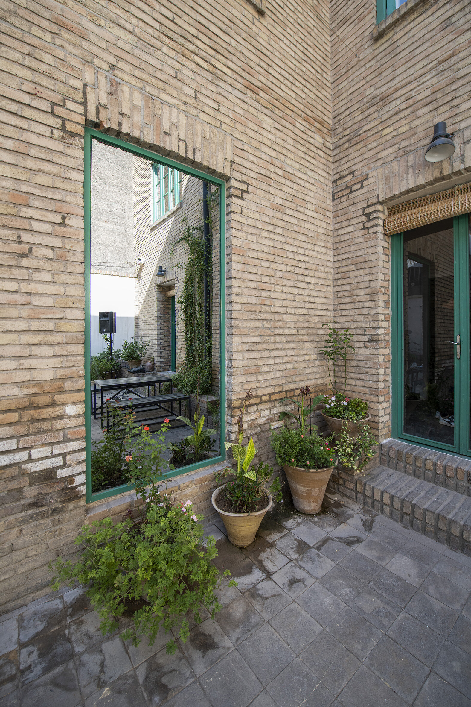  The courtyard view to: Untitled (One-way Mirror to the Communal Room)  One-way Mirror  230 x 109 CM (بدون عنوان (آینه یکطرفه به اطاق اشتراکی 