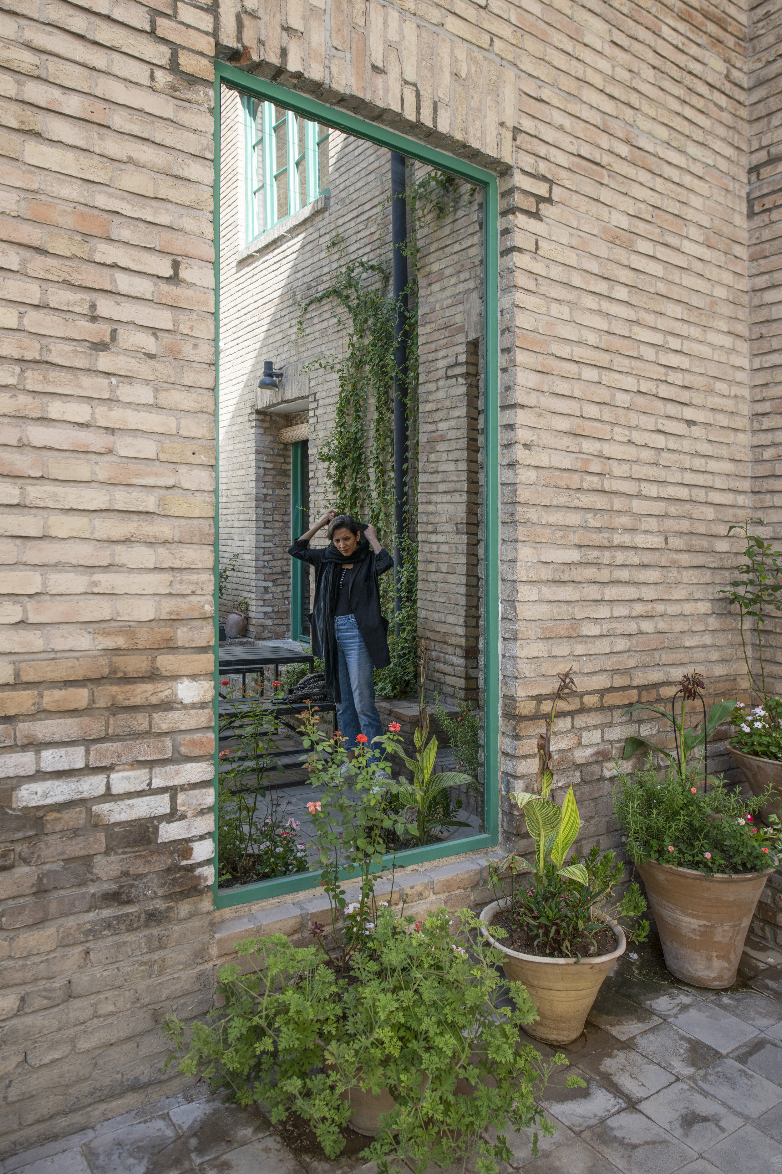  The courtyard view to: Untitled (One-way Mirror to the Communal Room)  One-way Mirror  230 x 109 CM (بدون عنوان (آینه یکطرفه به اطاق اشتراکی 