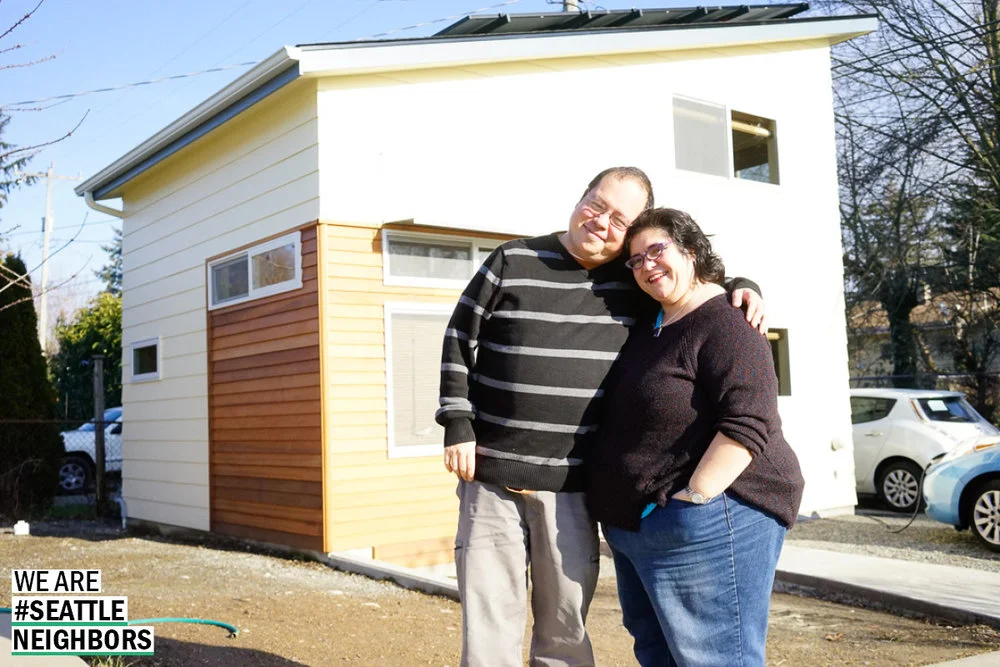 Kay and her husband stand in front of their backyard cottage built for her brother.