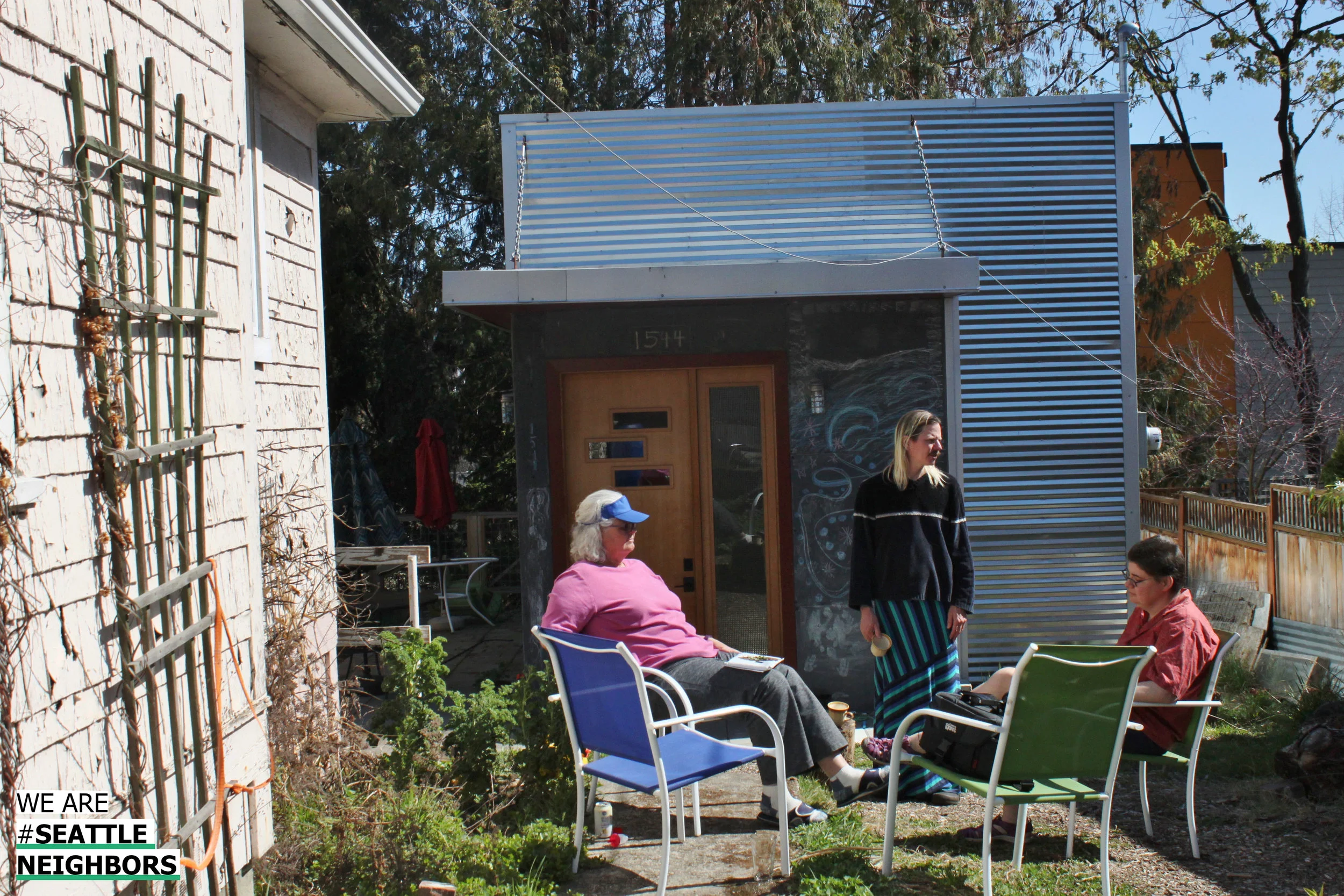 Jeannine (left) enjoys the sun outside her DADU with Adam (center) and Rachael (right).