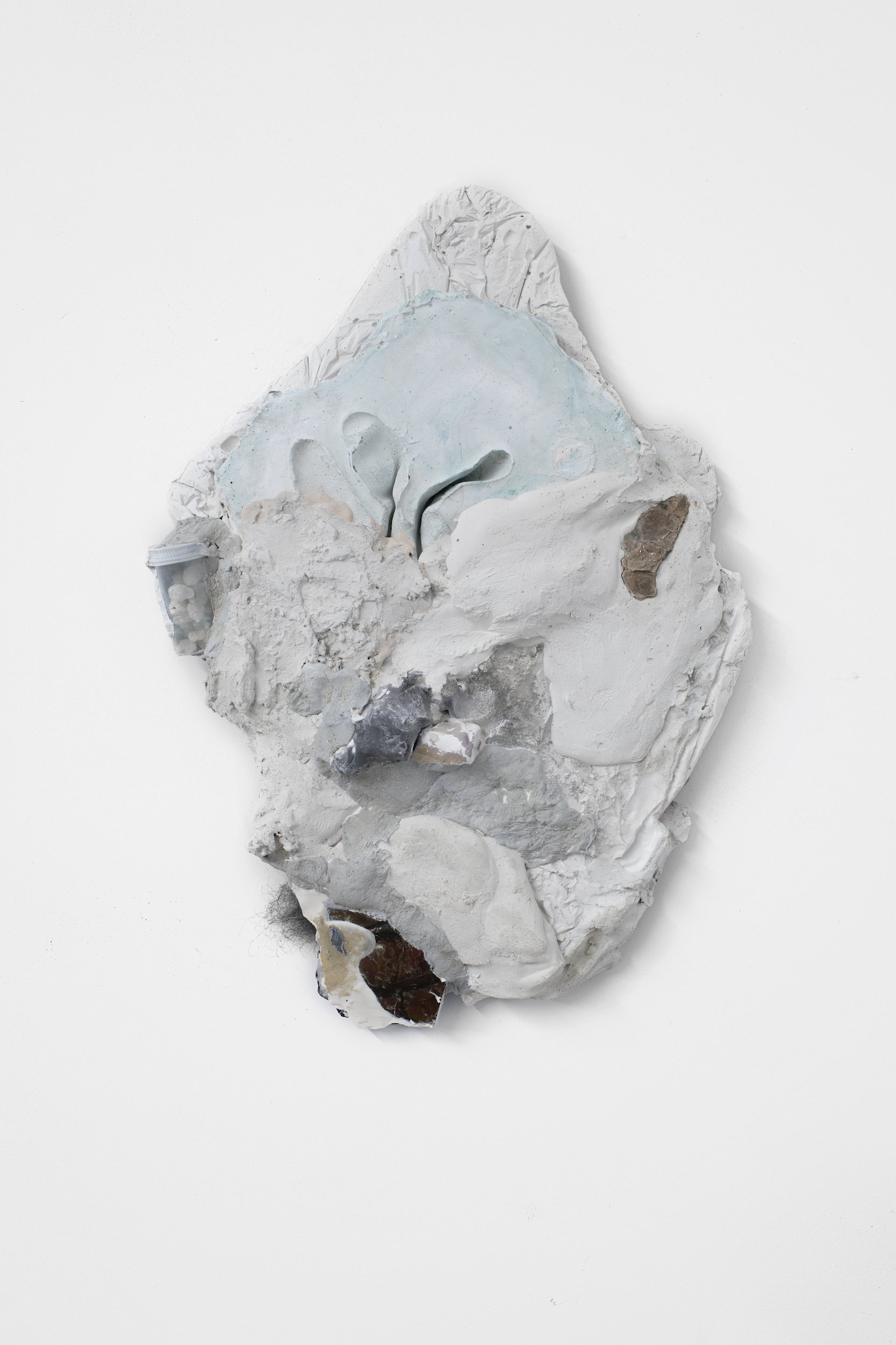  Laur P,  At last, our reshaped contours will be welcome , 2024, Plaster cast of gloves, rocks from childhood collection (muscovite mica, phlogopite mica), unfired clay, dry pigment, beads, steel wool, concrete sealant, pill bottle, cigarette butts, 