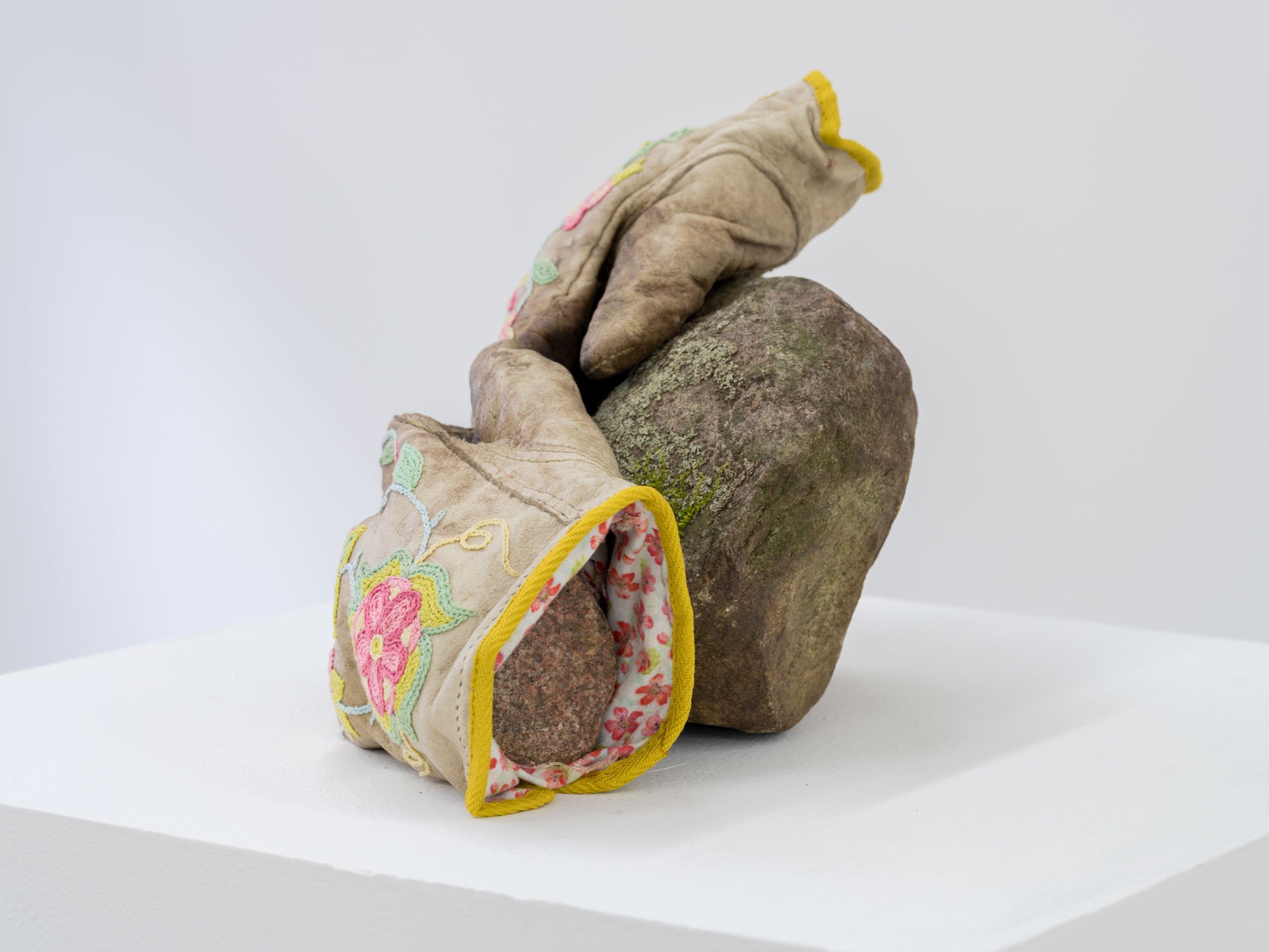 Haley Bassett,  The Rock Pickers , 2025, Worn work gloves, embroidery floss, twill tape, cotton fabric, thread, imitation sinew, field stones, 17.8 x 33 x 15.2 cm (7 x 13 x 6 ")