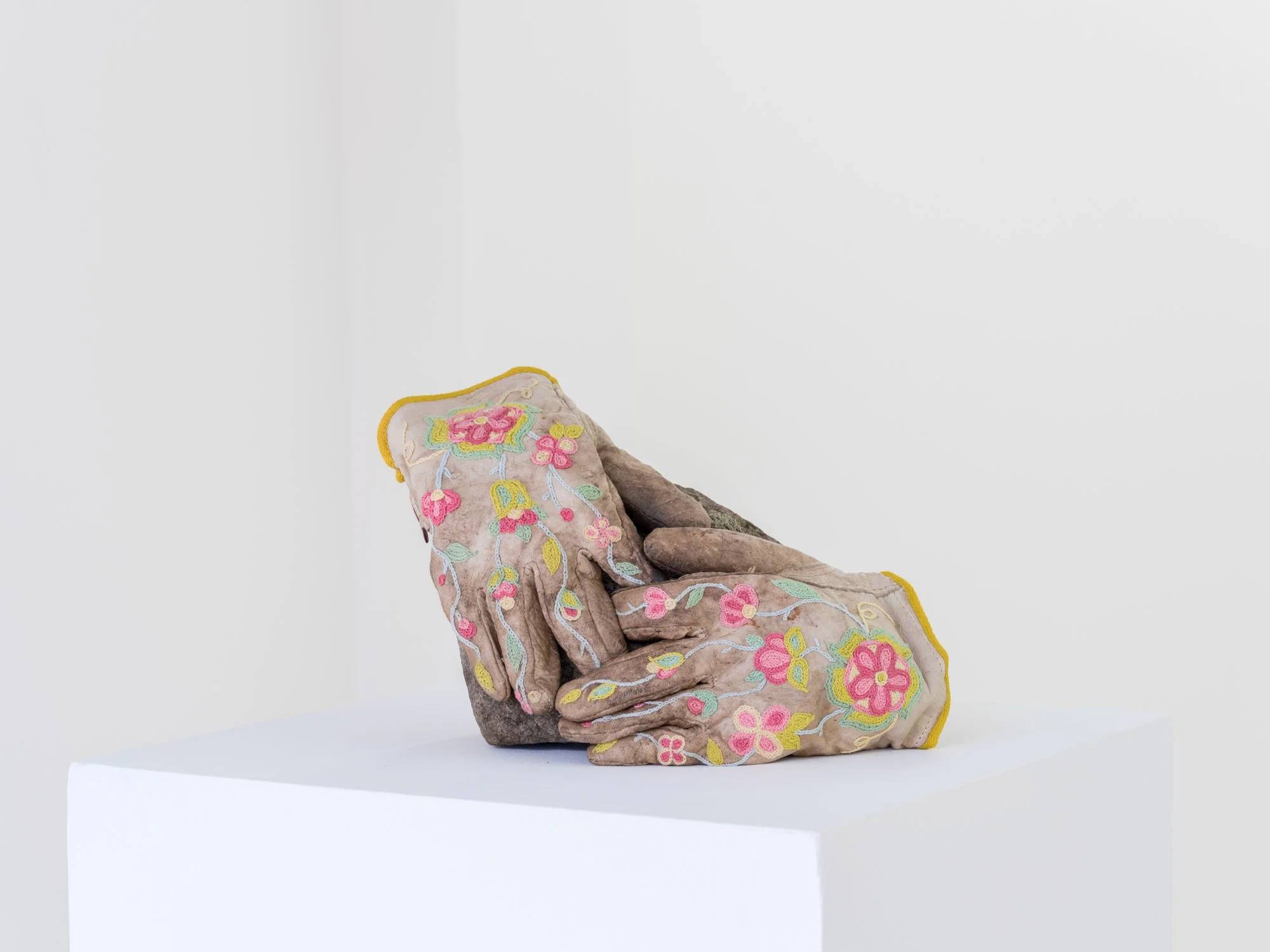 Haley Bassett,  The Rock Pickers , 2025, Worn work gloves, embroidery floss, twill tape, cotton fabric, thread, imitation sinew, field stones, 17.8 x 33 x 15.2 cm (7 x 13 x 6 ")