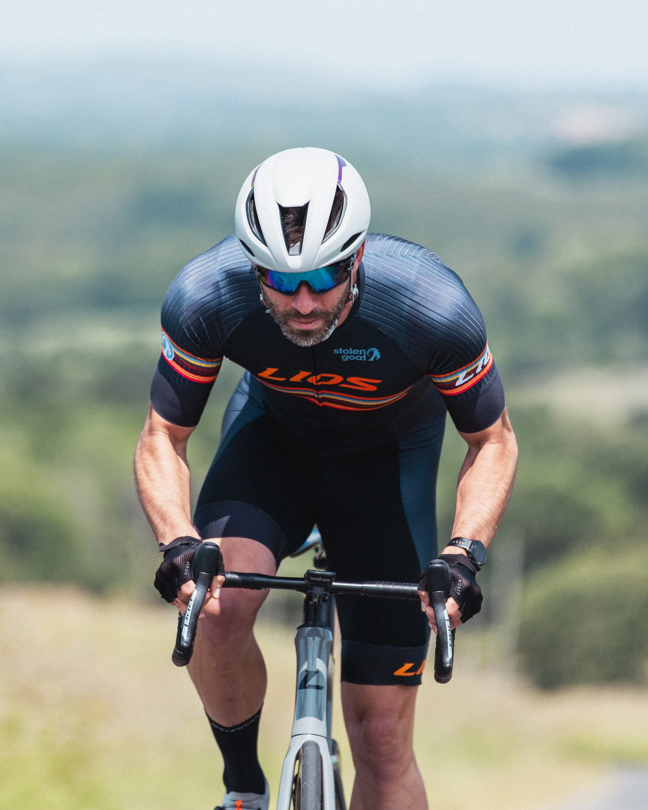 LIOS cyclist riding in an aggressive aero posture on a LIOS Exactor aero road bike.