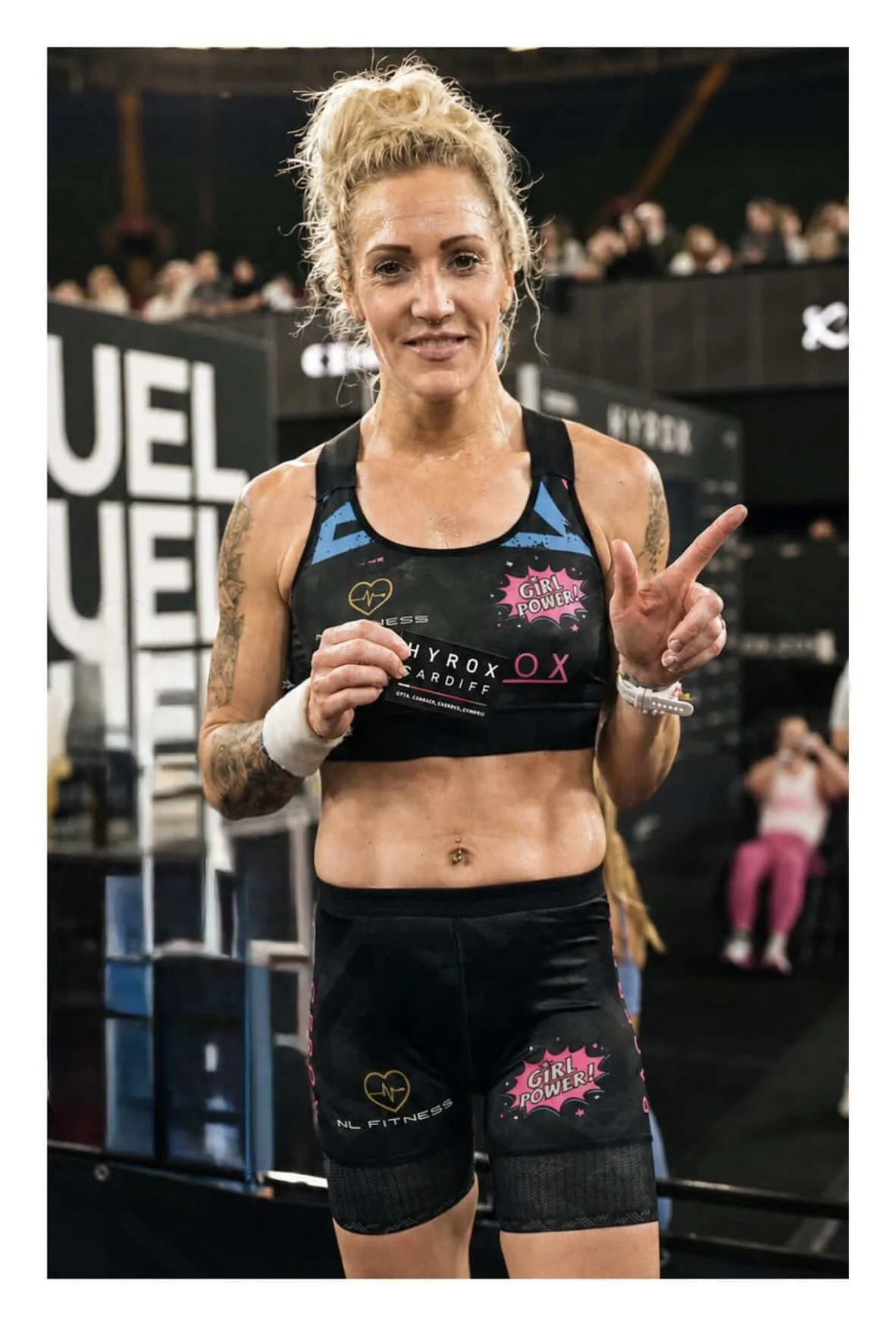 Nat Lawrence holding a HYROX Cardiff patch after winning the Women’s Pro race in Wales.