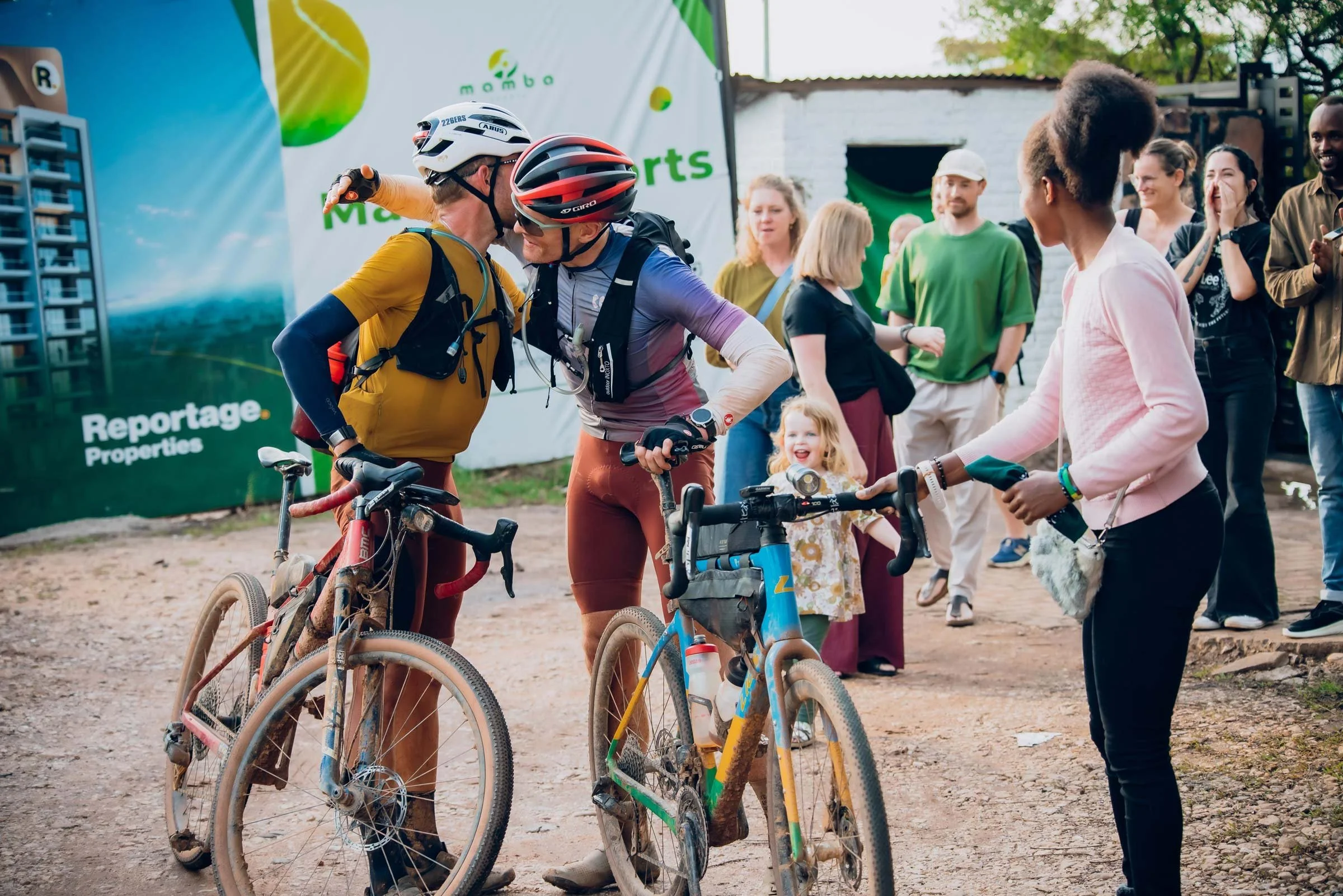 Matt Brokenshire and Ulrich Bartholmoes embracing after Race Around Rwanda finish