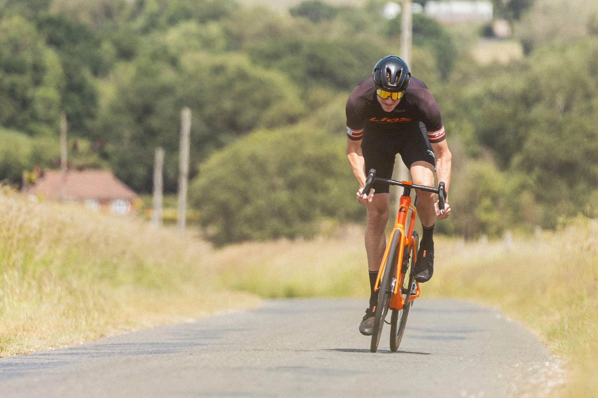 LIOS Ambassador Marc Ryan sprinting head on along a country lane on his LIOS Exactor carbon aero road bike.
