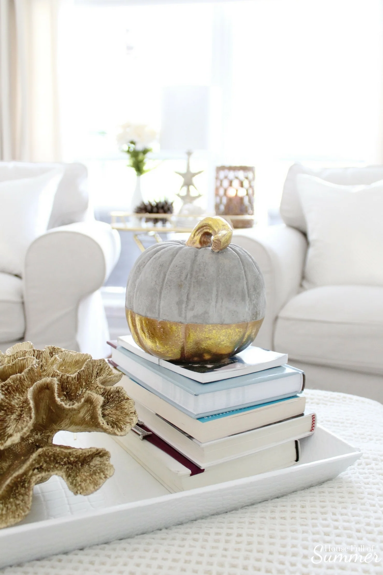 House Full of Summer: Fall Home Tour Blog Hop - Cozy, Coastal, Chic Living Room fall decorating ideas. Neutral interior, living room decor, gold dipped pumpkin, gold coral, living room ideas, sitting room, wood floors, table styling, pine cones, gold accents, home goods