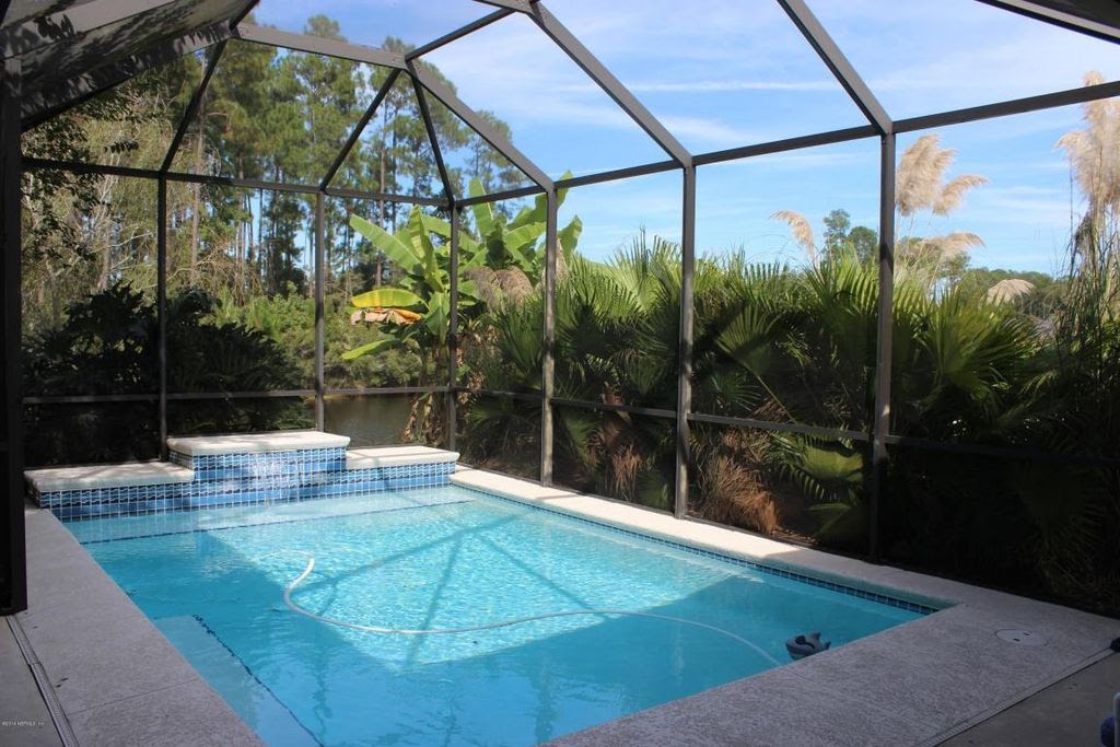  How We Turned Our Boring Backyard Into a Our Own Little Slice of Paradise | House Full of Summer backyard before and afters pool enclosure Florida home water view backyard design, coastal home, overgrown backyard, patio design, pool and pond 