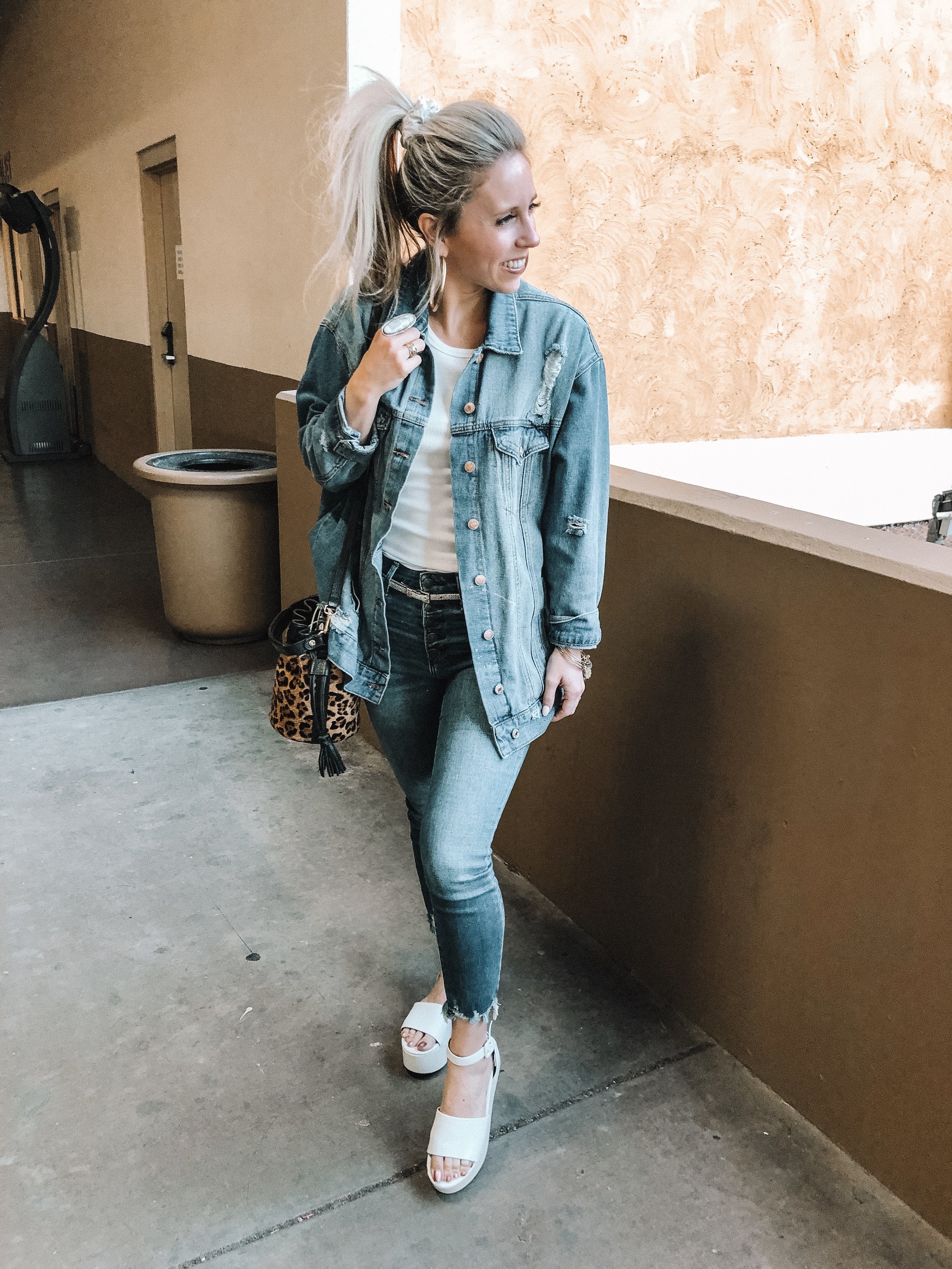 Denim trend featured by top US fashion blog, Life of a Sister: image of a woman wearing a distressed denim jacket