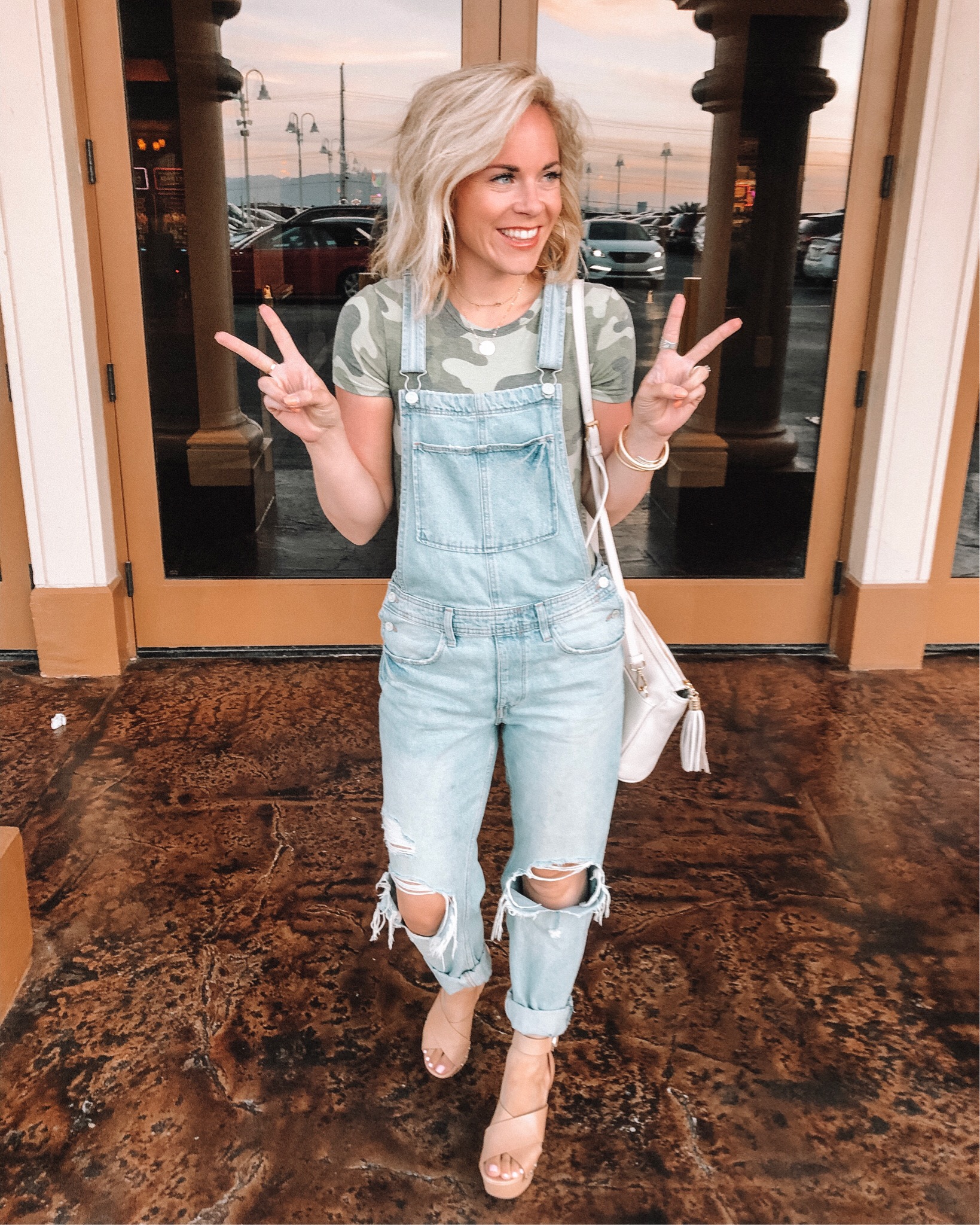 Denim trend featured by top US fashion blog, Life of a Sister: image of a woman wearing denim overalls