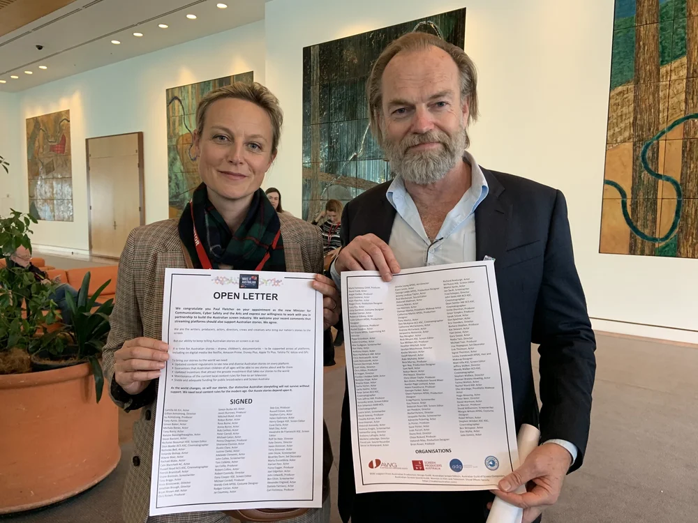  MEAA members Marta Dusseldorp and Hugo Weaving with copies of the open letter to Communications and Arts Minister Paul Fletcher. 