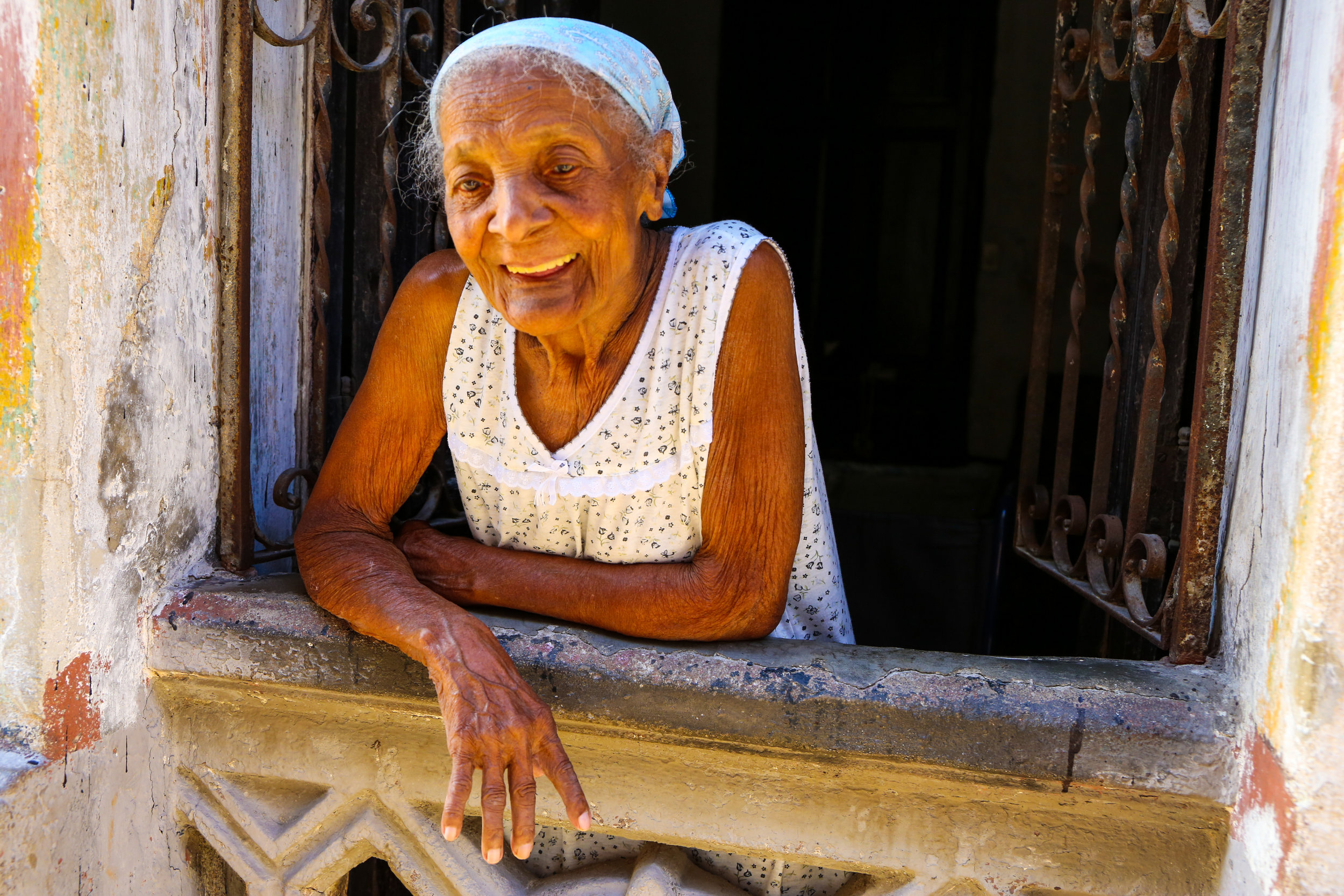 A woman watches kids play on the street. March 2019 in the Centro neighborhood of Havana, Cuba.