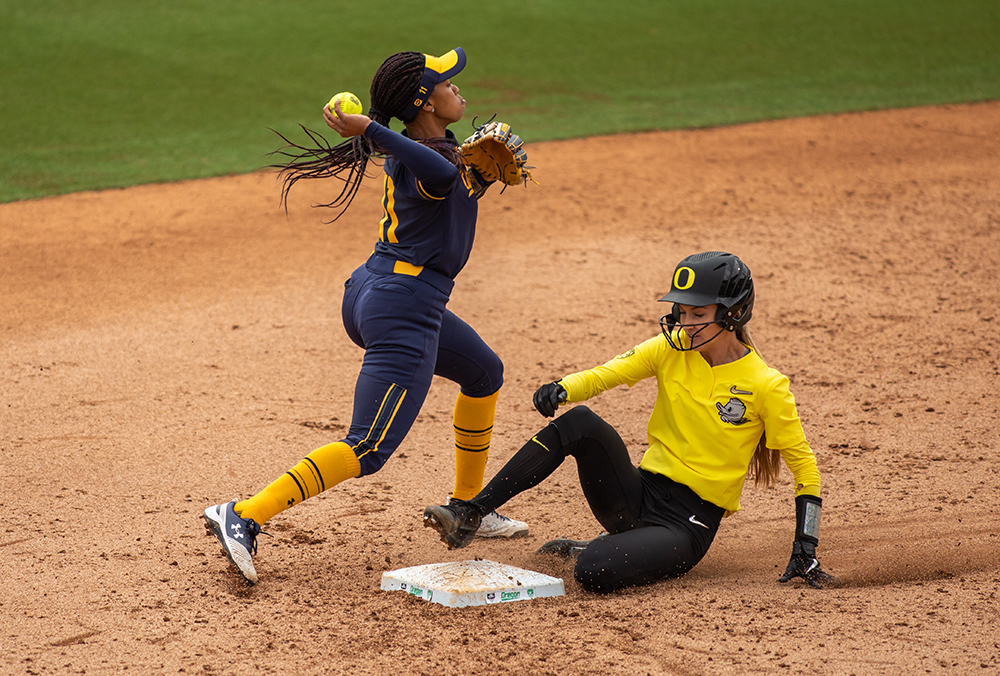  UC Berkeley's Destiny Blueford sends the ball to first after tagging out University of Oregon center fielder Haley Cruse in the third inning of game three in a series against the Golden Bears Saturday, April 20, 2019, at Jane Sanders Stadium in Euge