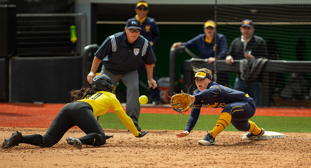  UC Berkeley's Makena Smith catches out University of Oregon left fielder Cherish Burks at first on a double play during game three in a series against UC Berkeley Saturday, April 20, 2019, at Jane Sanders Stadium in Eugene. The Ducks lost 3-5, but w