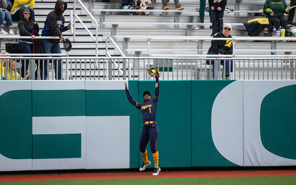  UC Berkeley center fielder Amani Bradley catches a pop fly at the wall off of University of Oregon third baseman Rachel Cid during game three in a series against UC Berkeley Saturday, April 20, 2019, at Jane Sanders Stadium in Eugene. The Ducks lost