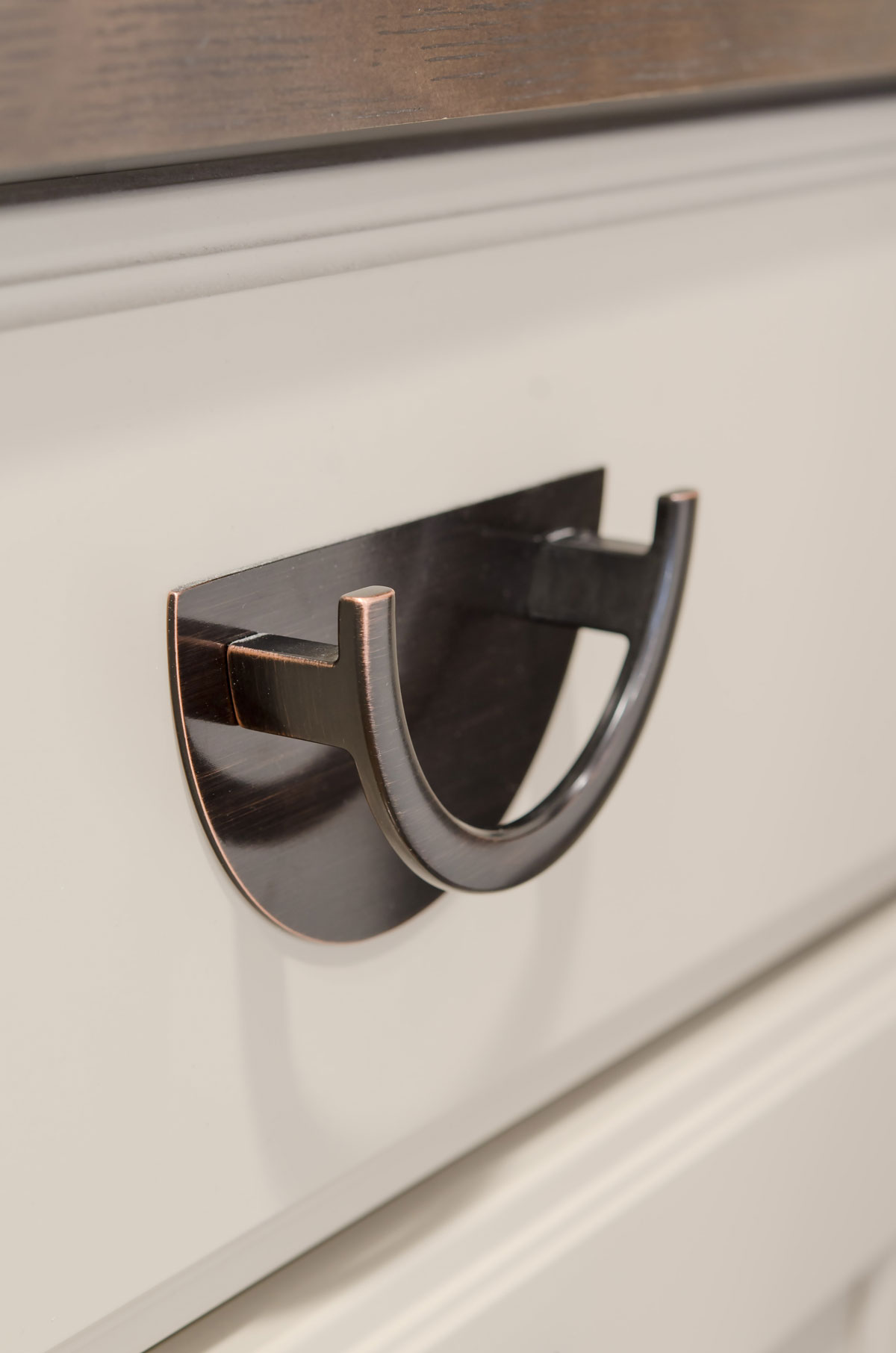 Bronze hardware on maple laundry room cabinets
