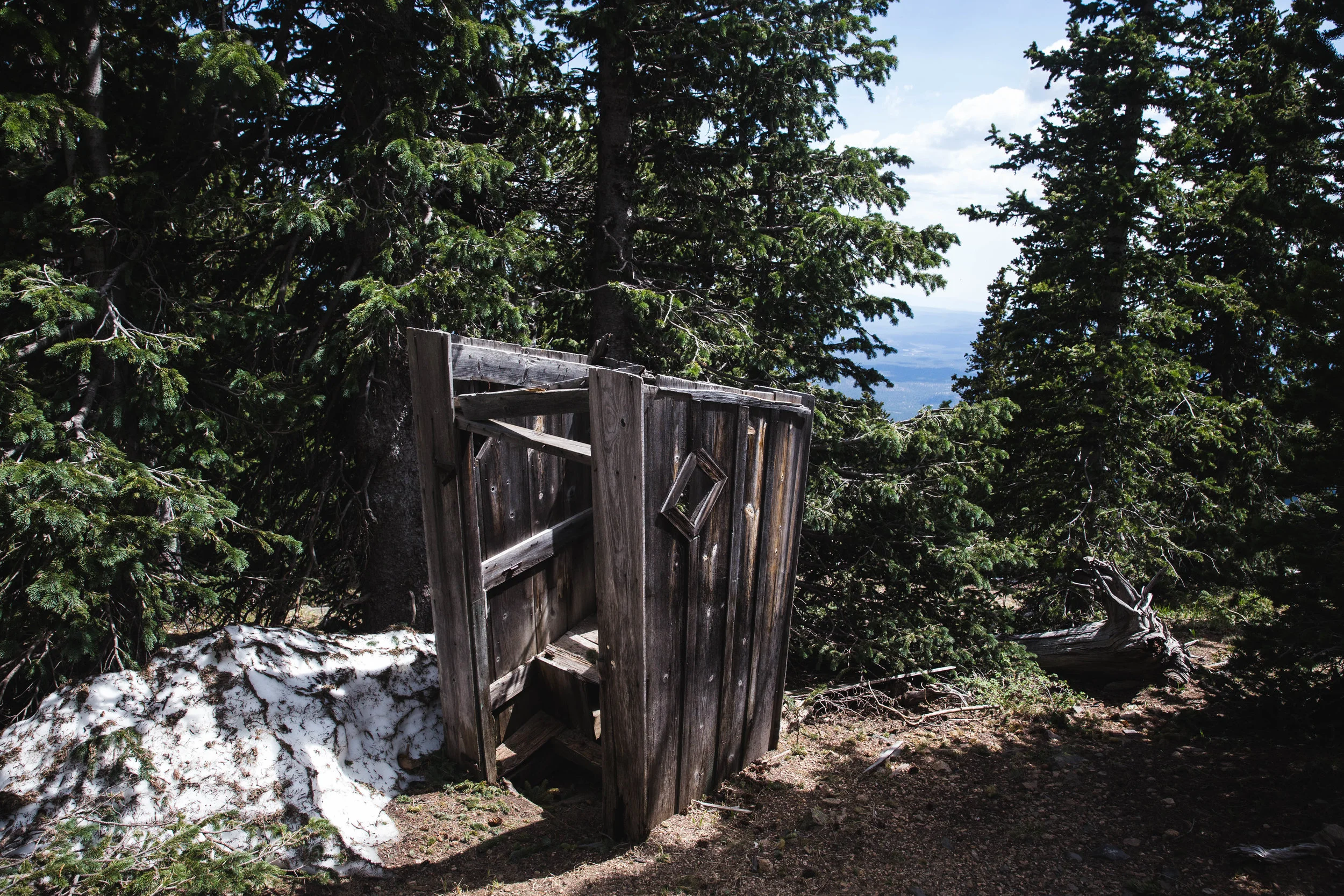 This outhouse is located on the saddle between Abineau and Freemont in the Kachina Peaks wilderness. This outhouse is out of commission, either someone laid one hell of a crap in there or the deep snow forced it off its foundation. In any case, I do not recommend using this guy, but the views were not bad. RATING: ★★☆☆☆