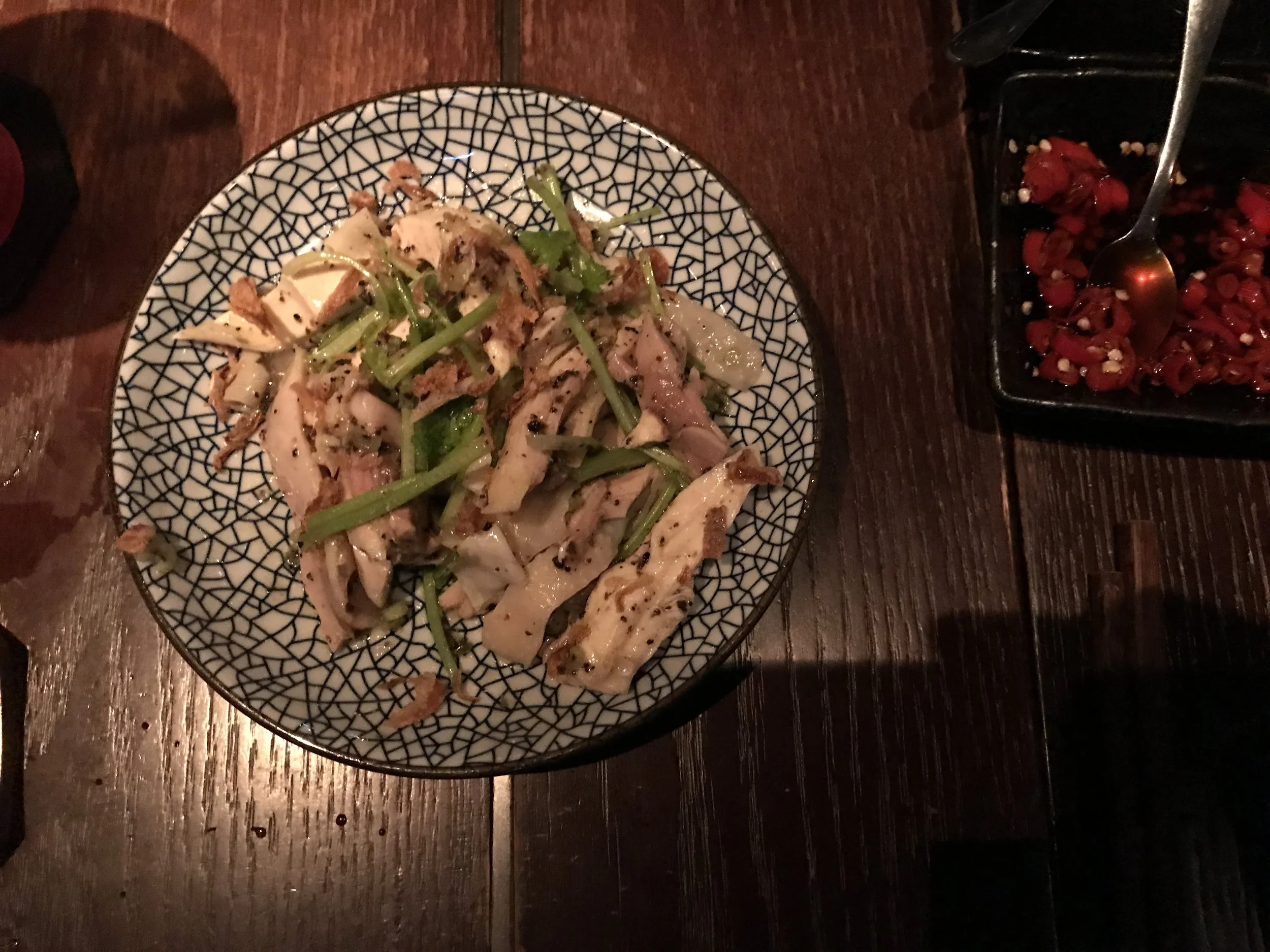 An earthy-chicken, served refreshingly cold, topped with green beans and drizzled with truffle