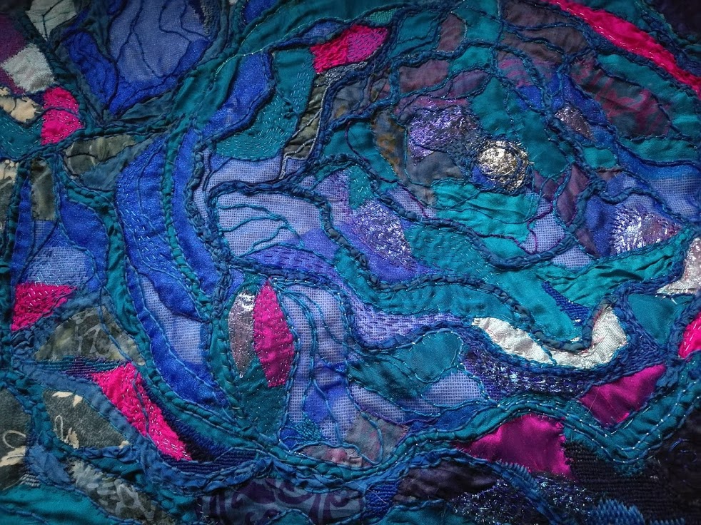 Rose Window: a hand-stitched textile work incorporating fabric and threads on a linen scrim canvas.