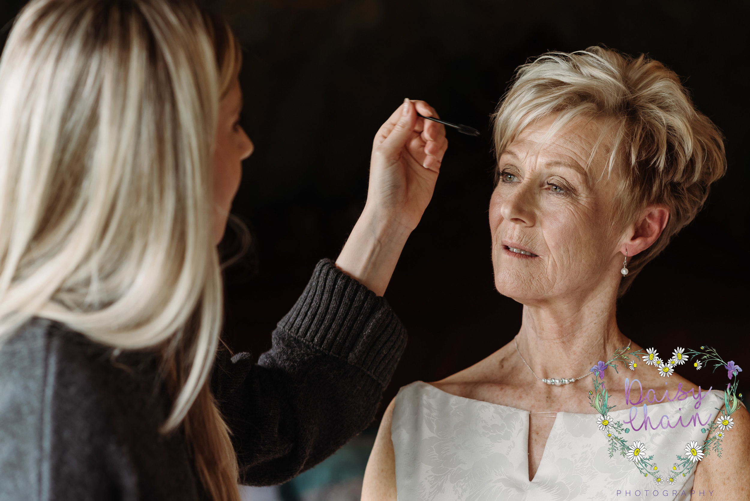 finishing touches to wedding makeup
