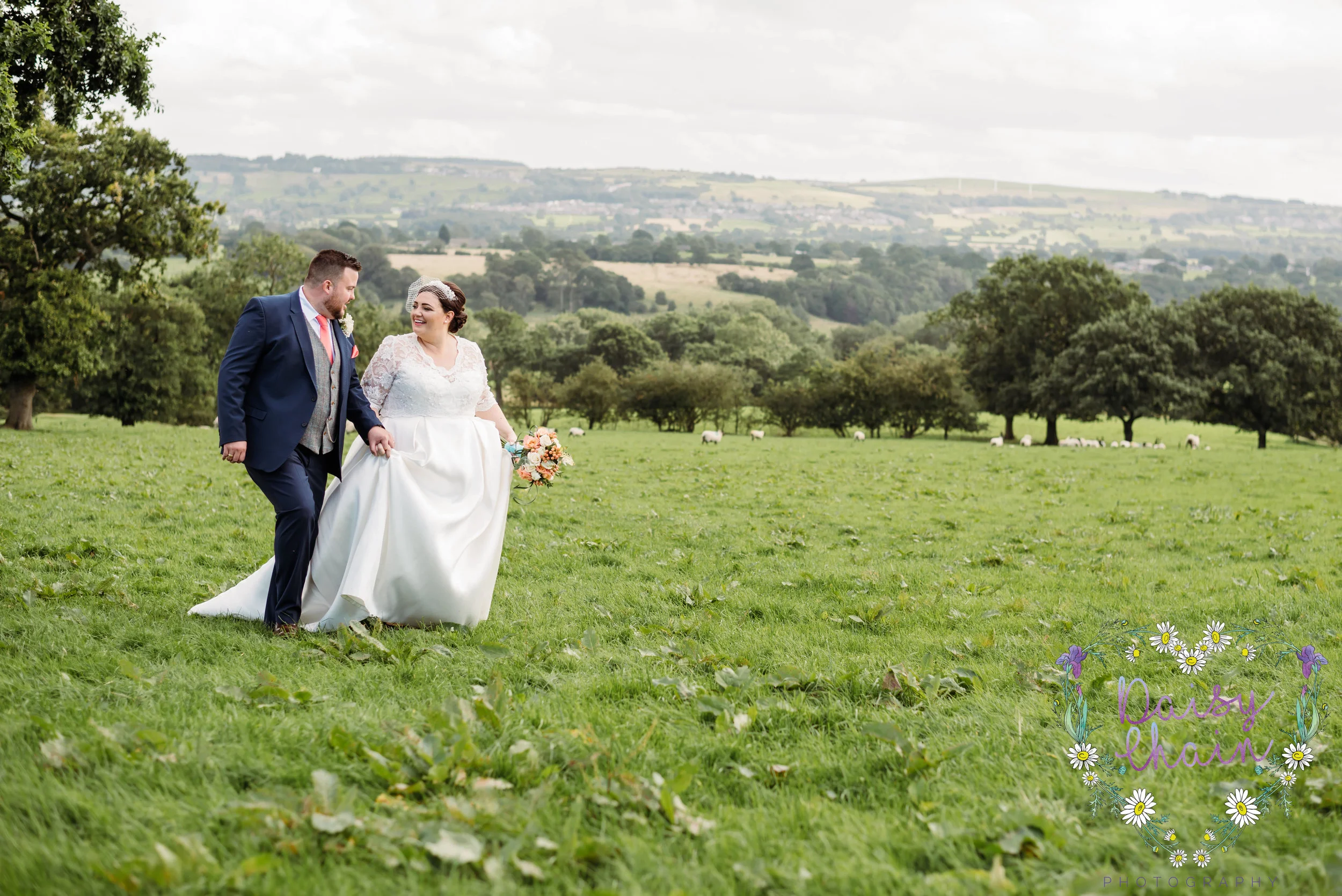 Bride and groom walking in a field