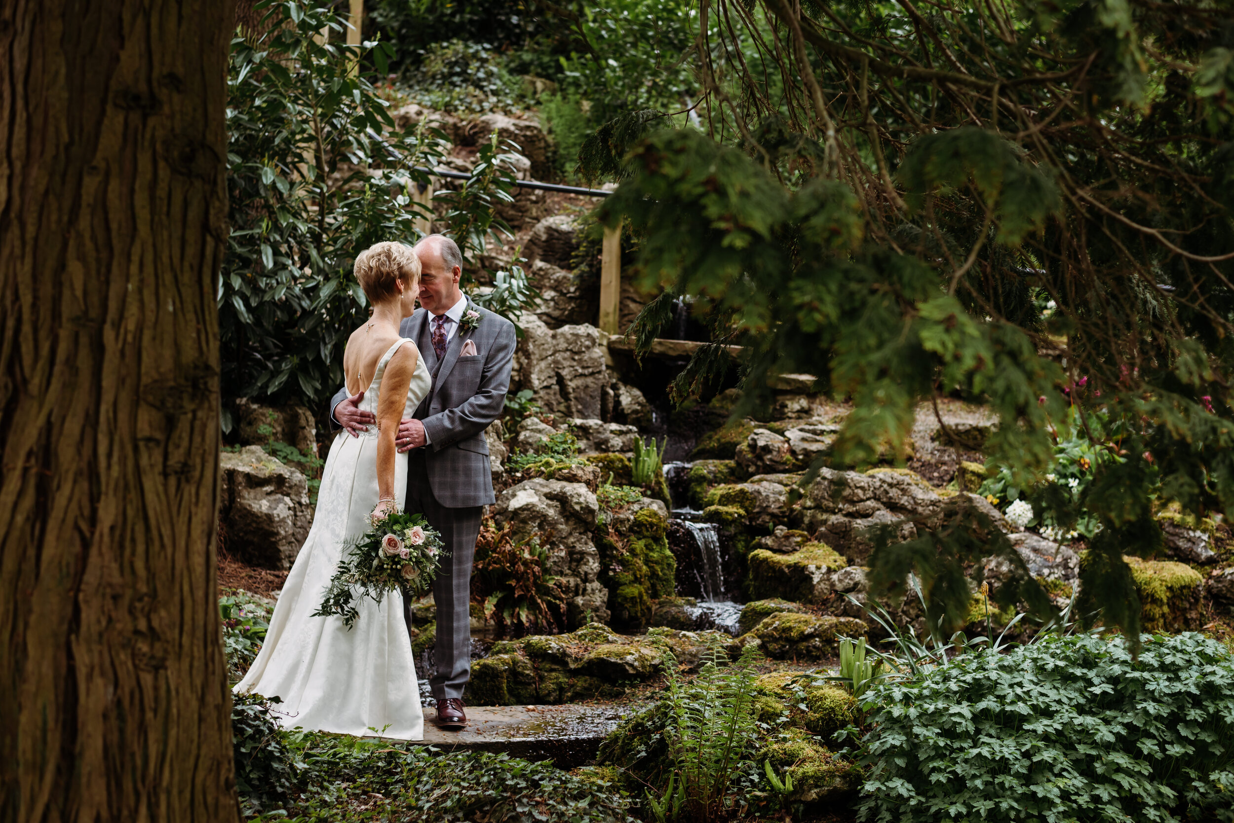 Bride and groom in the secret garden at Mitton Hall
