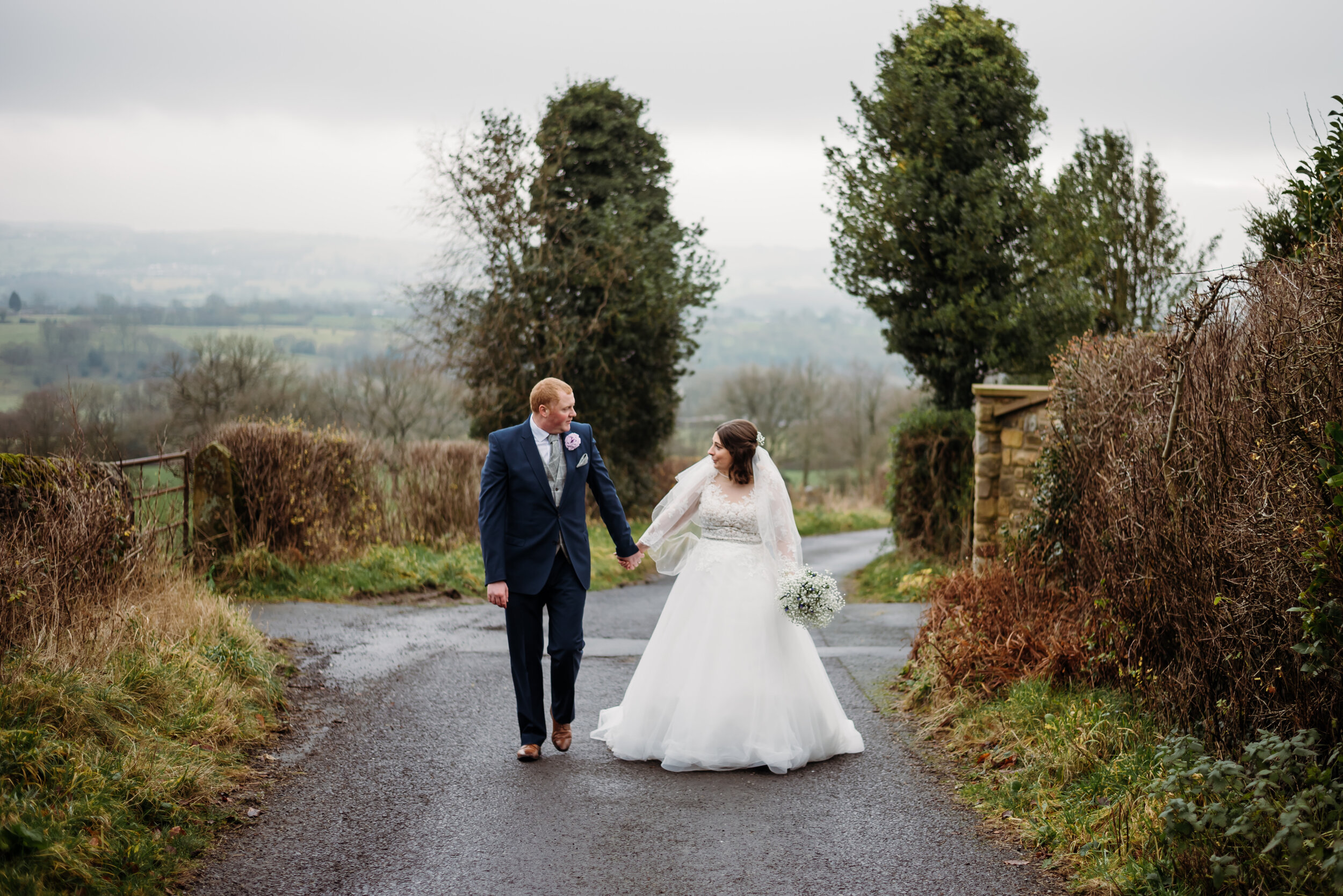 Bride and groom walking on a lane