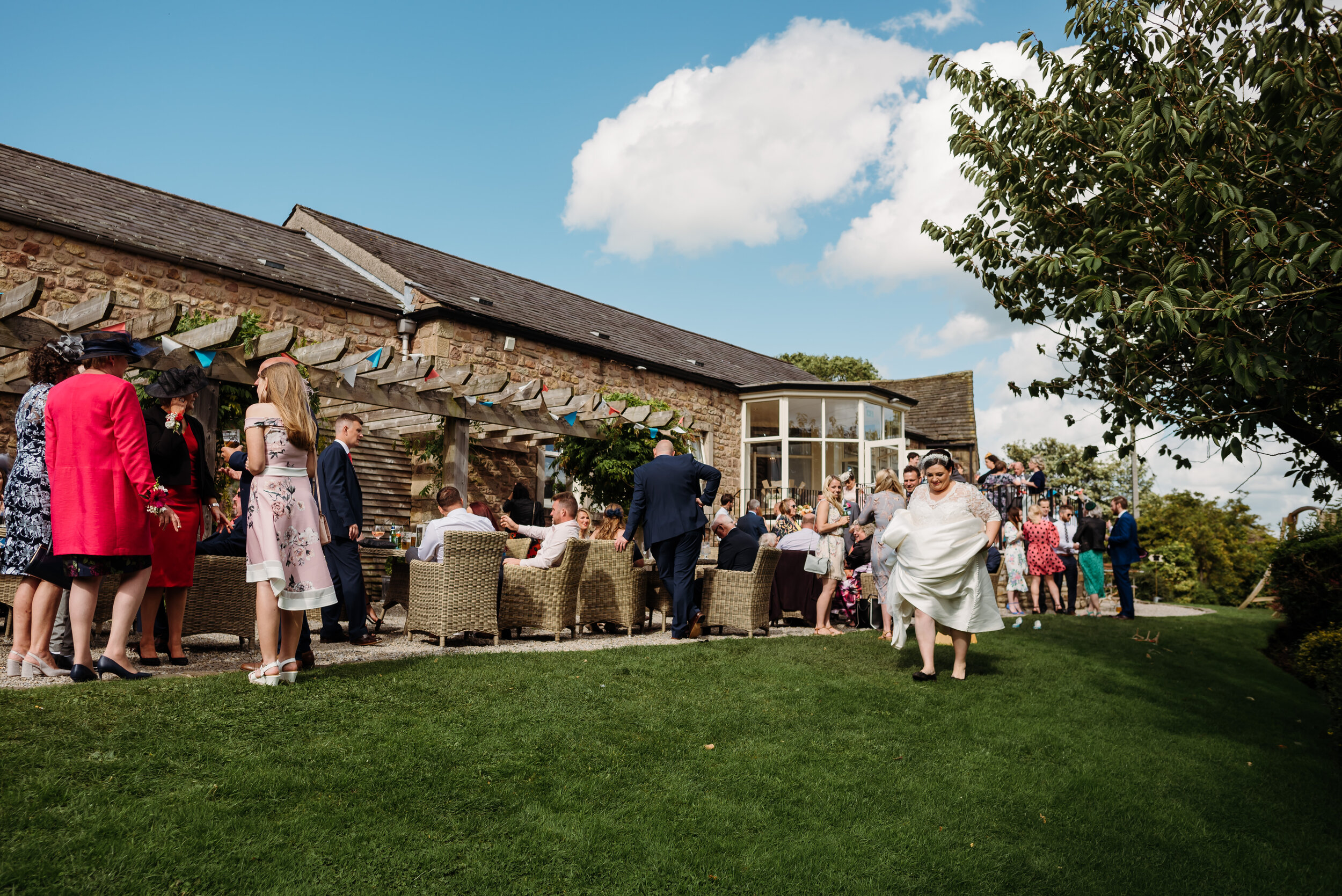 Wedding guests in the garden enjoying the sun at the Shireburn Arms
