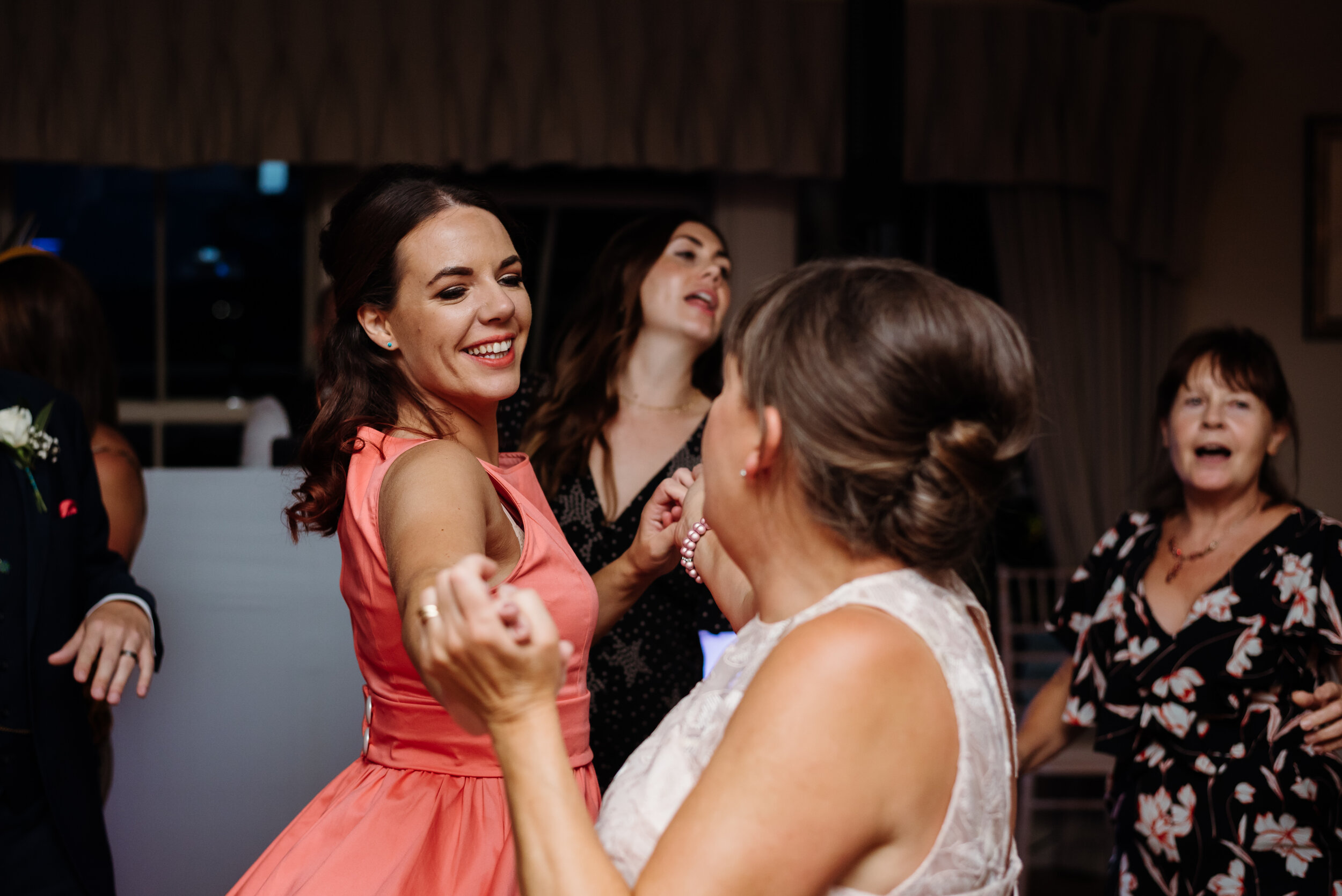 Bridesmaid dancing with mother of the bride