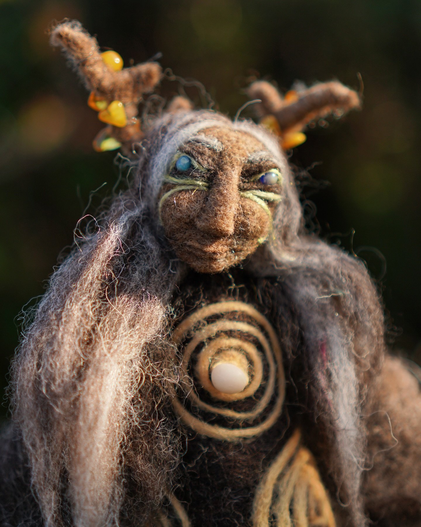 Winter Sun ~ I sat up late on the eve of the Solstice to complete her. The circles on her dress are woven in wool dyed with heather flower and are based on the cup and ring carvings in Scotland. The small bead is carved from an agate found on the Sco