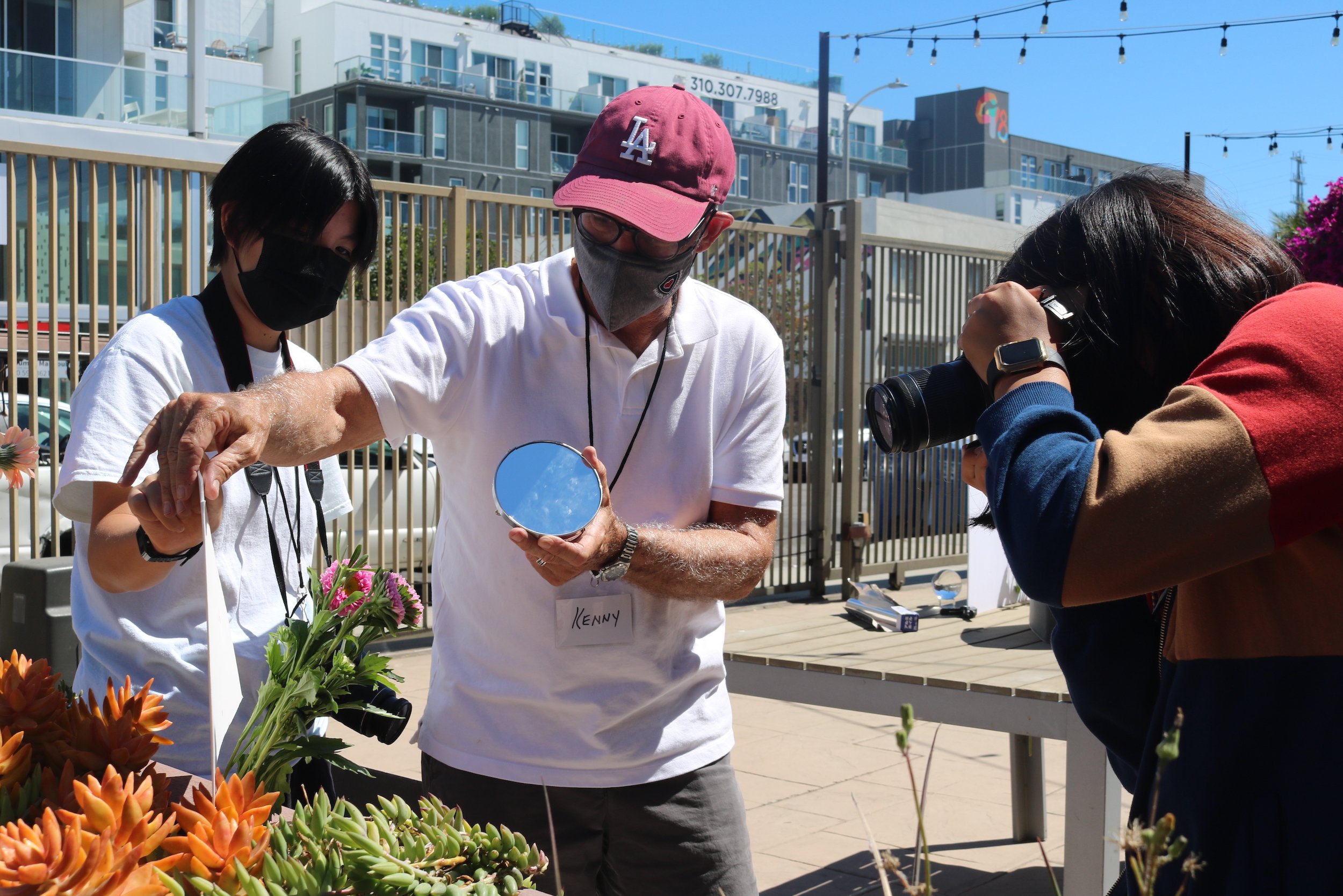  Mentor Ken helps students experiment photographing light and color using mirrors and gels. 